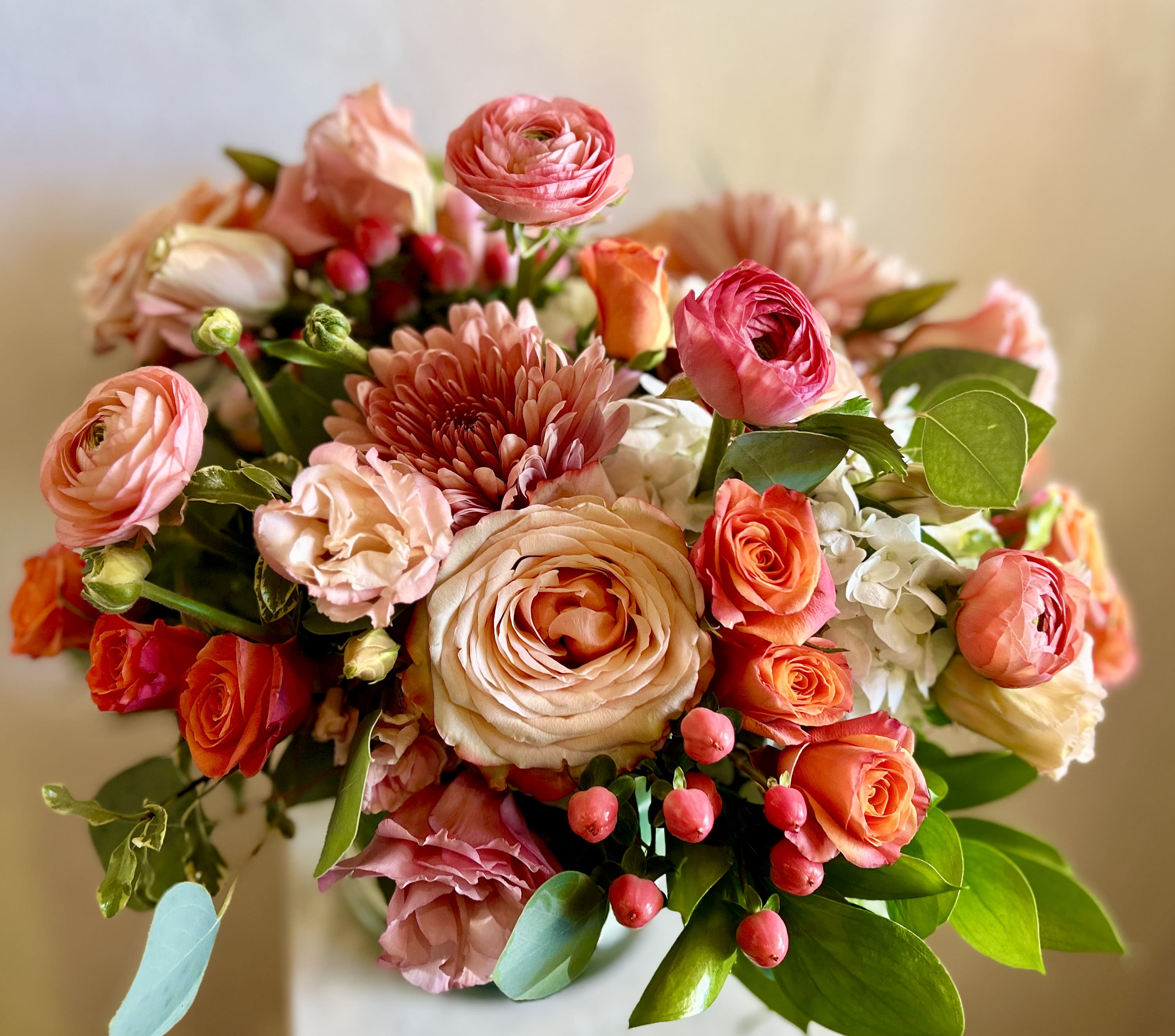 Bouquet of pink and peach flowers with roses and ranunculus