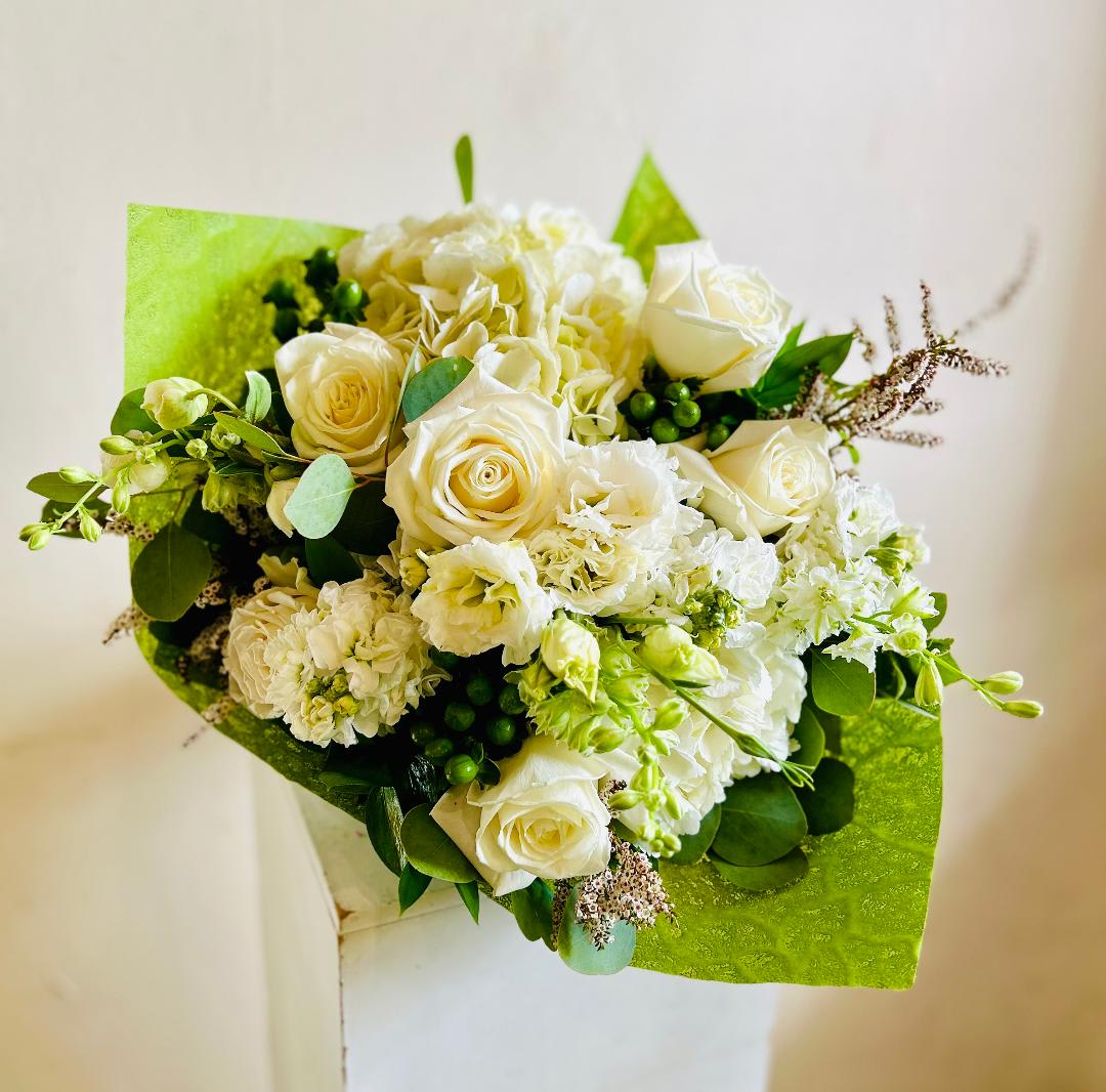 White roses and hydrangeas in bright green wrapping