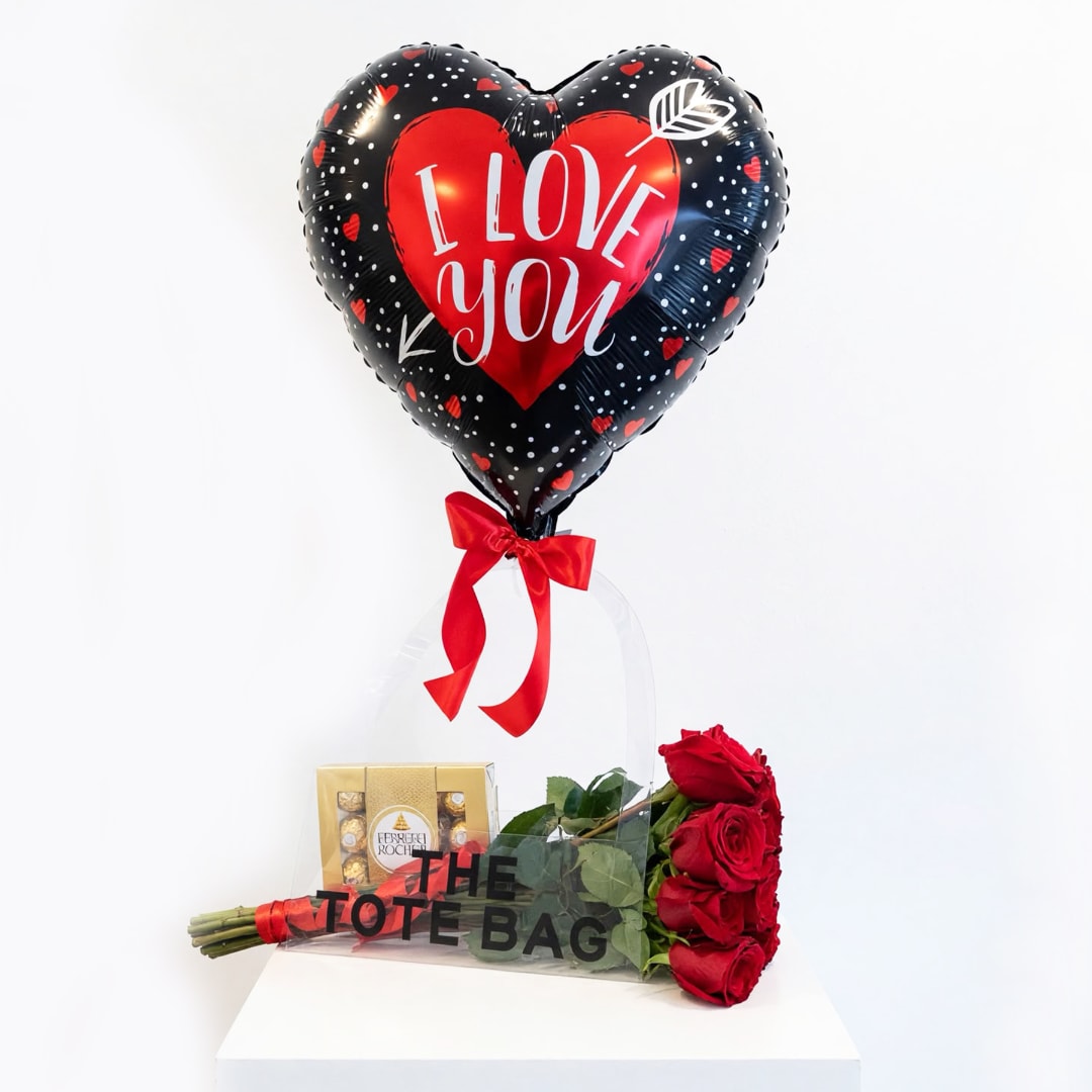 Heart balloon with roses and a chocolate box in a clear gift bag