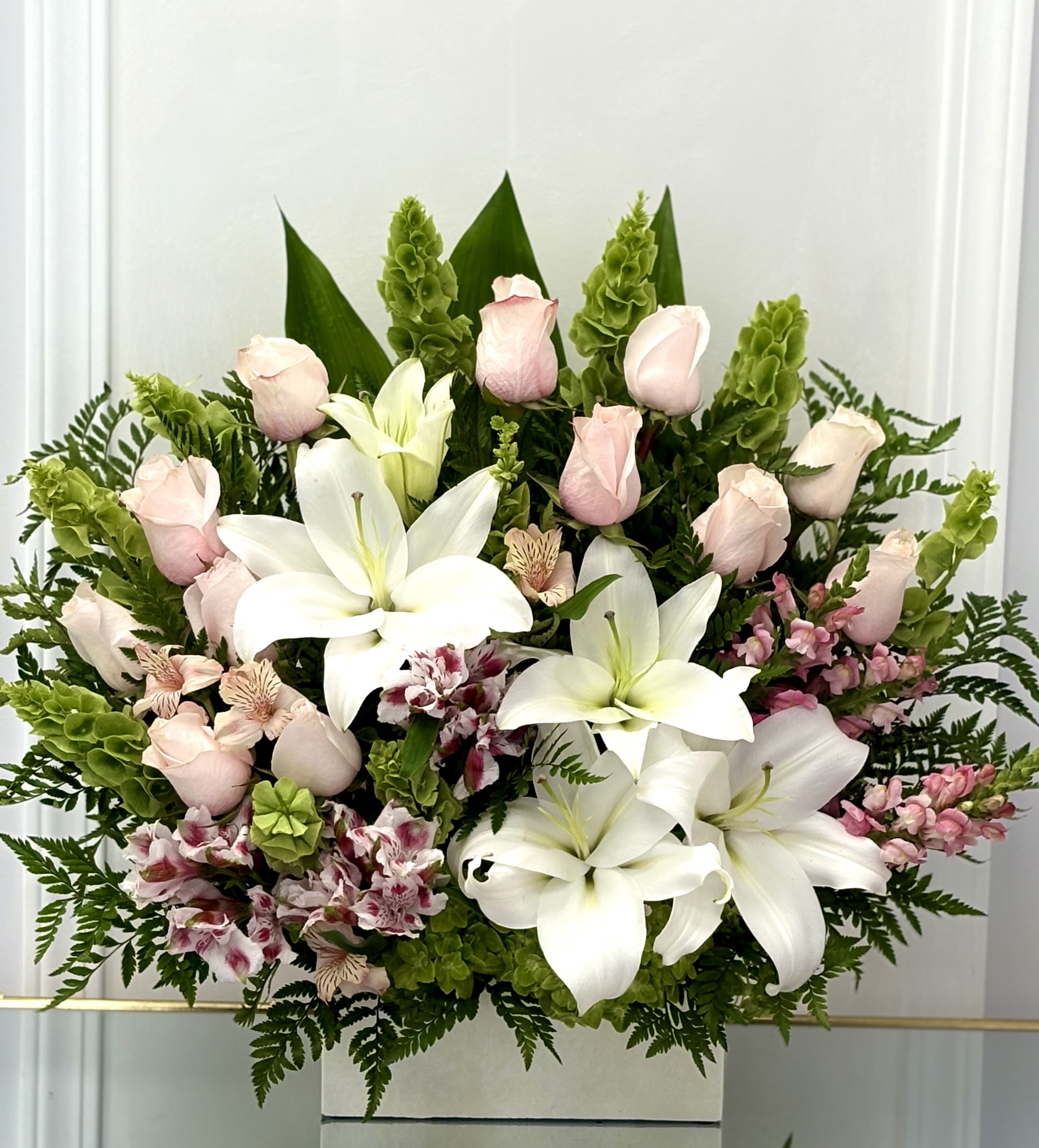 Bouquet of white lilies, pale pink roses, and pink alstroemeria