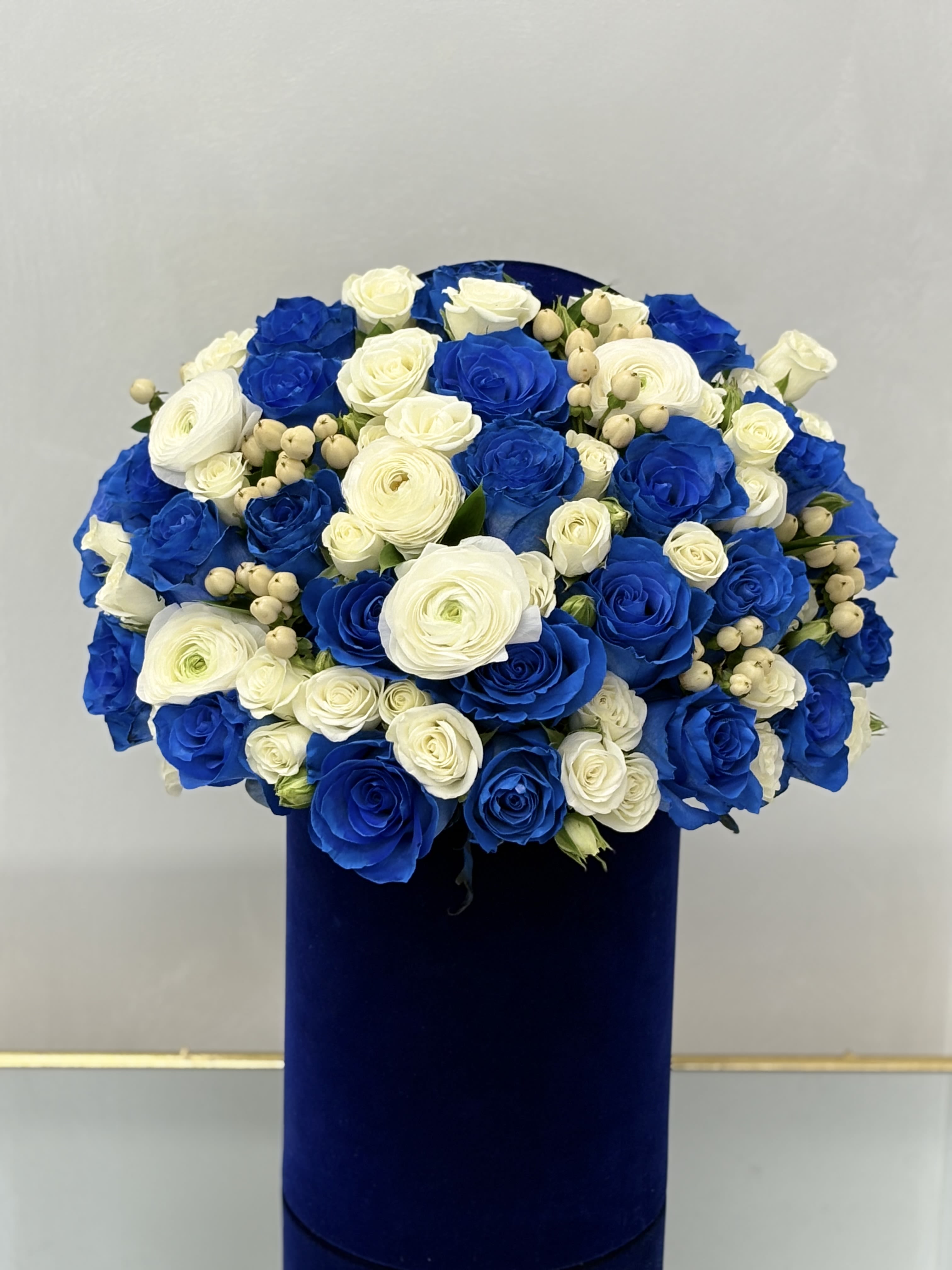 Blue and white rose bouquet in a dark blue box