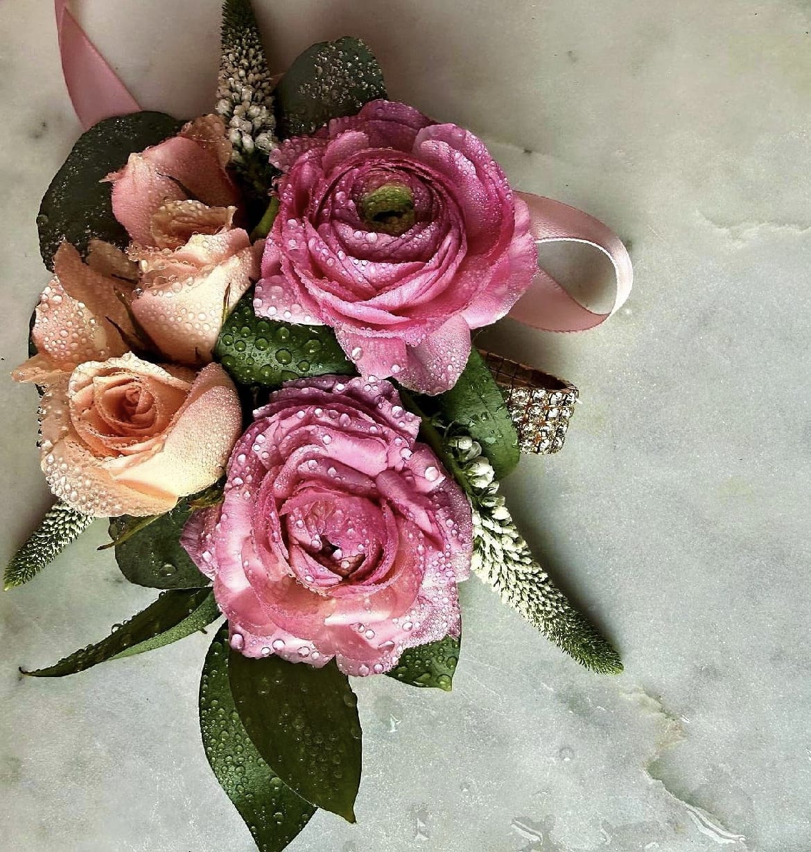 Bridgerton Blush Gold Bracelet Wrist Corsage by Evergreen Elegance  - Complementing the ranunculus are light pink spray roses, eucalyptus and green leaves with a diamond crystals gold elastic wristband .