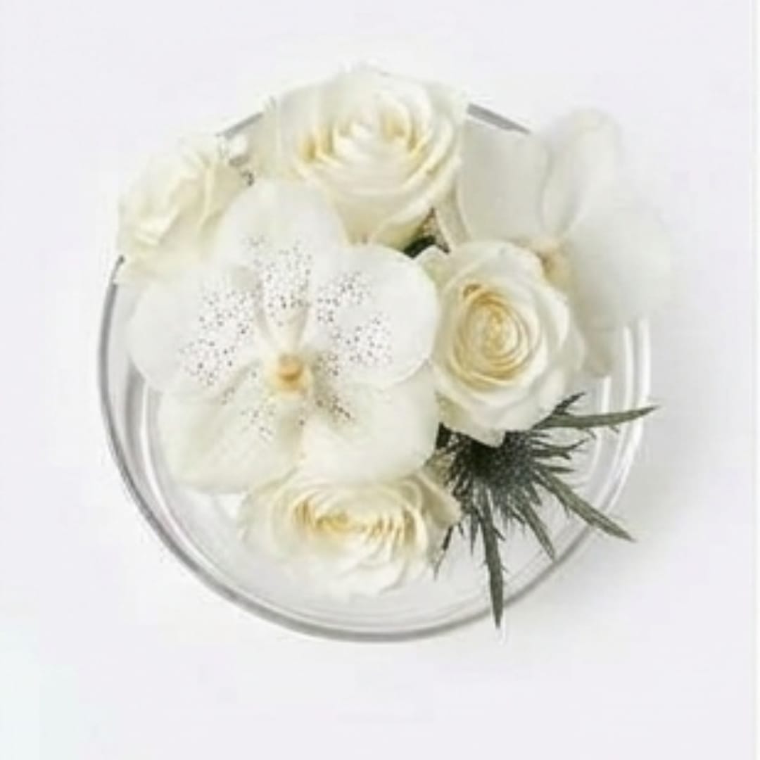 White floral bouquet in a clear round container