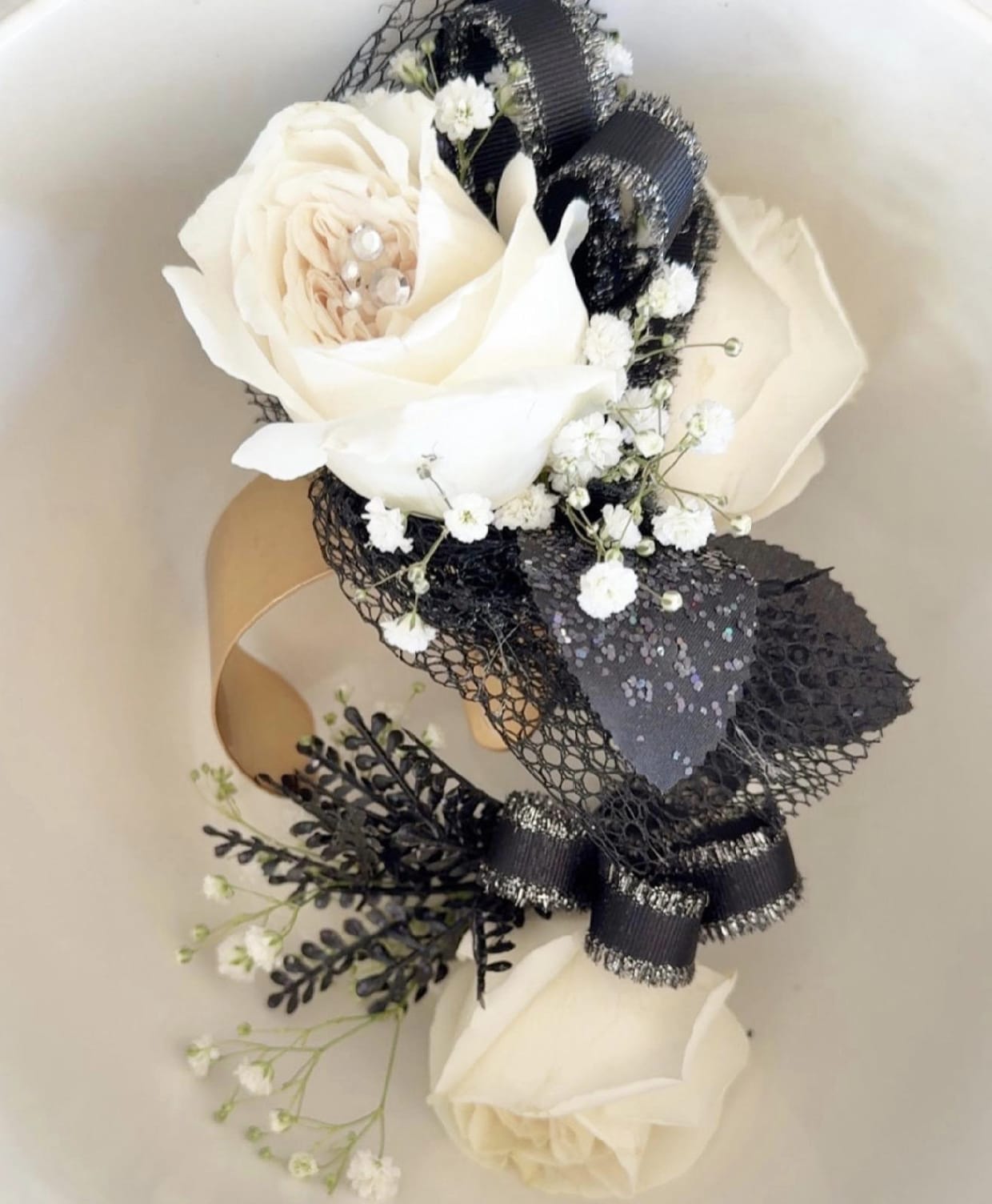 White rose bouquet with black ribbon and baby's breath