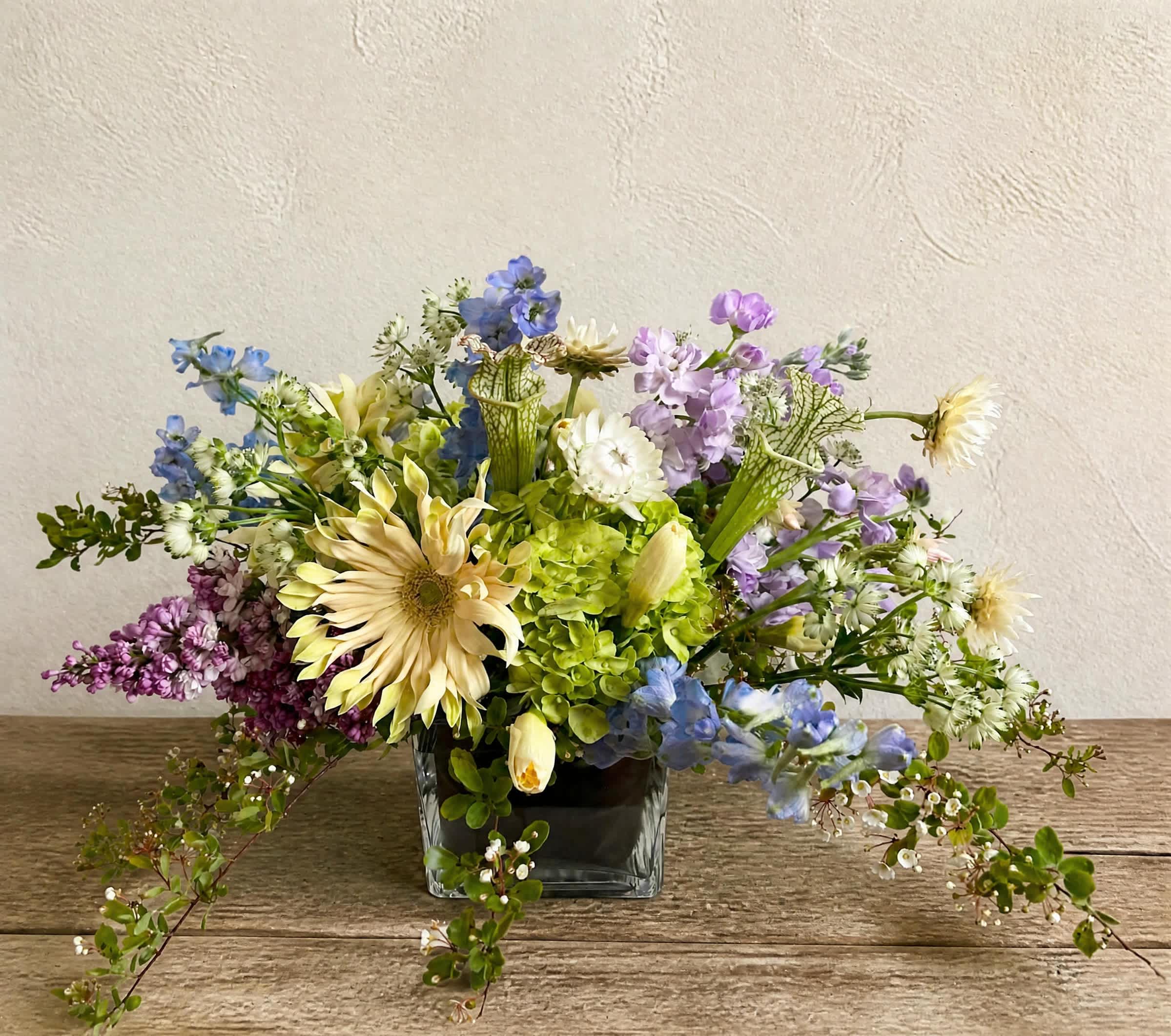 Mixed pastel bouquet in a square glass vase