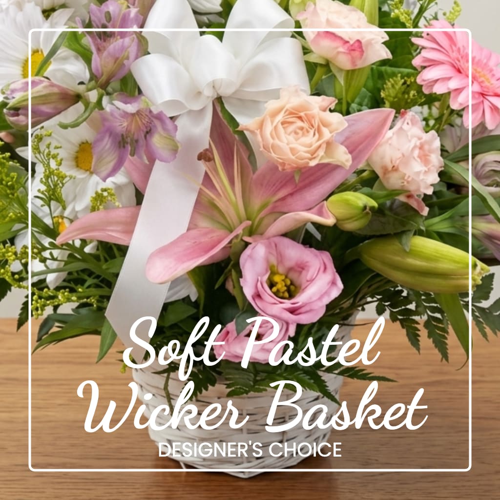 Pastel mixed flower basket with a white ribbon and wicker container