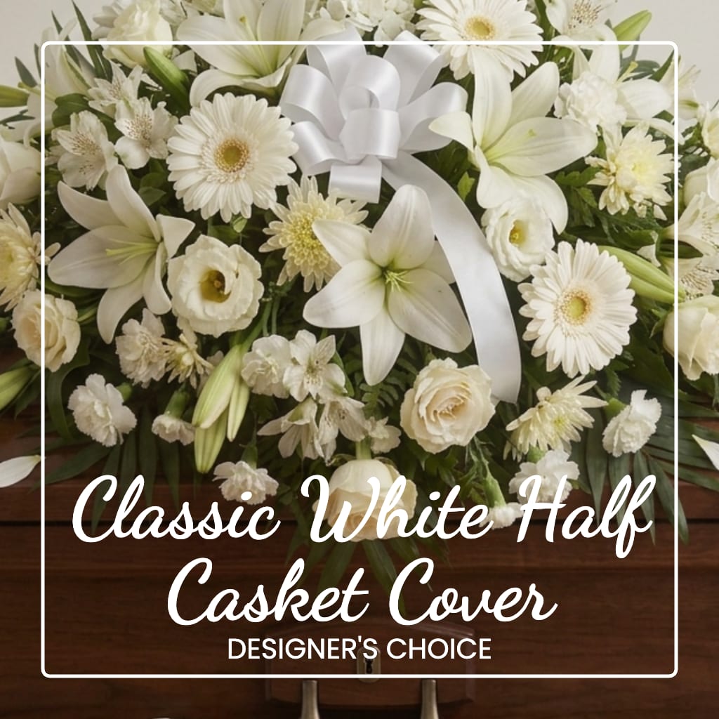 White floral casket cover with a satin bow and mixed blooms