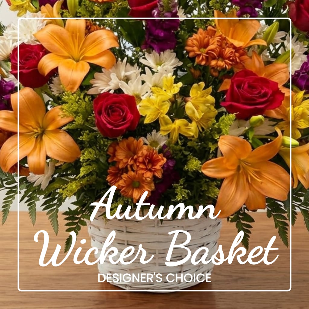 Autumn flower basket with roses, lilies, and daisies in a white wicker basket