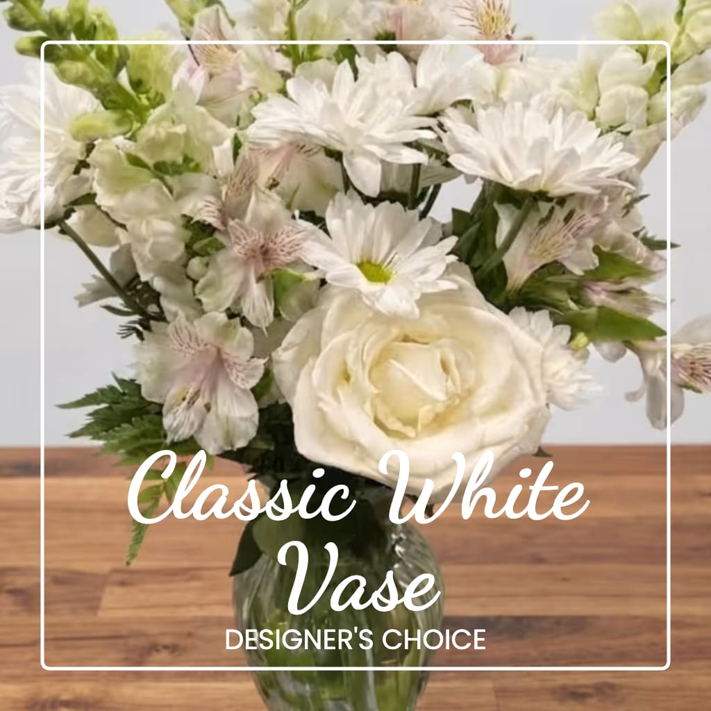 White floral bouquet in a glass vase with mixed blooms