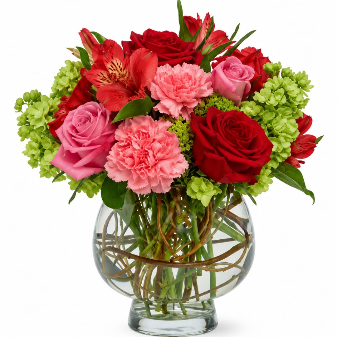 Bouquet of red and pink flowers in a clear glass vase