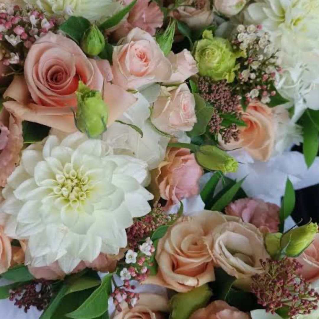 Bouquet of blush roses and white dahlias with small filler flowers
