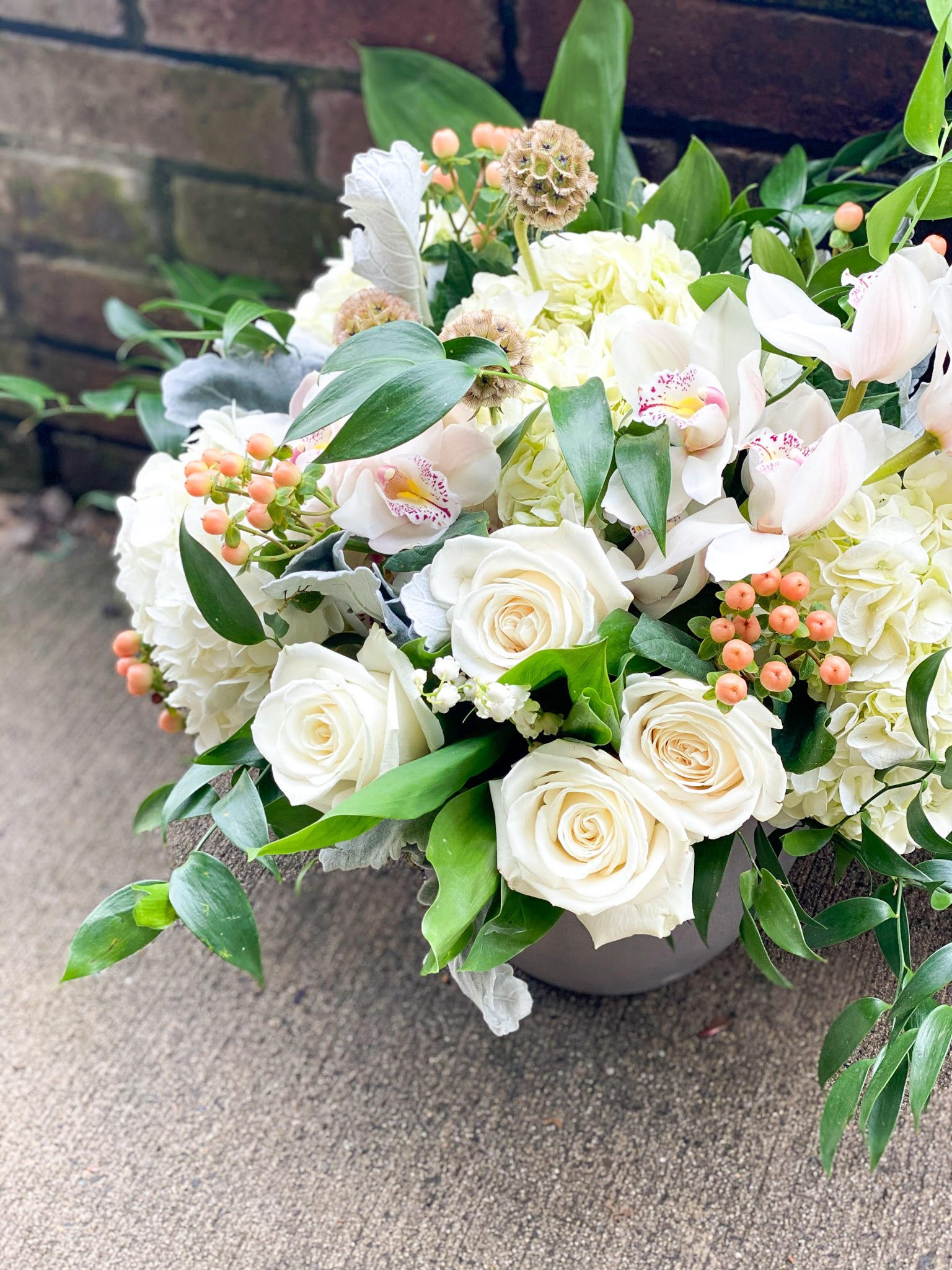 The Hypericum  - Elegant design in a stone pot. This airy and lush arrangement will have your loved ones shocked by its beauty! 