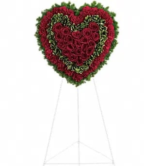 Heart-shaped standing floral spray with red roses and green edging