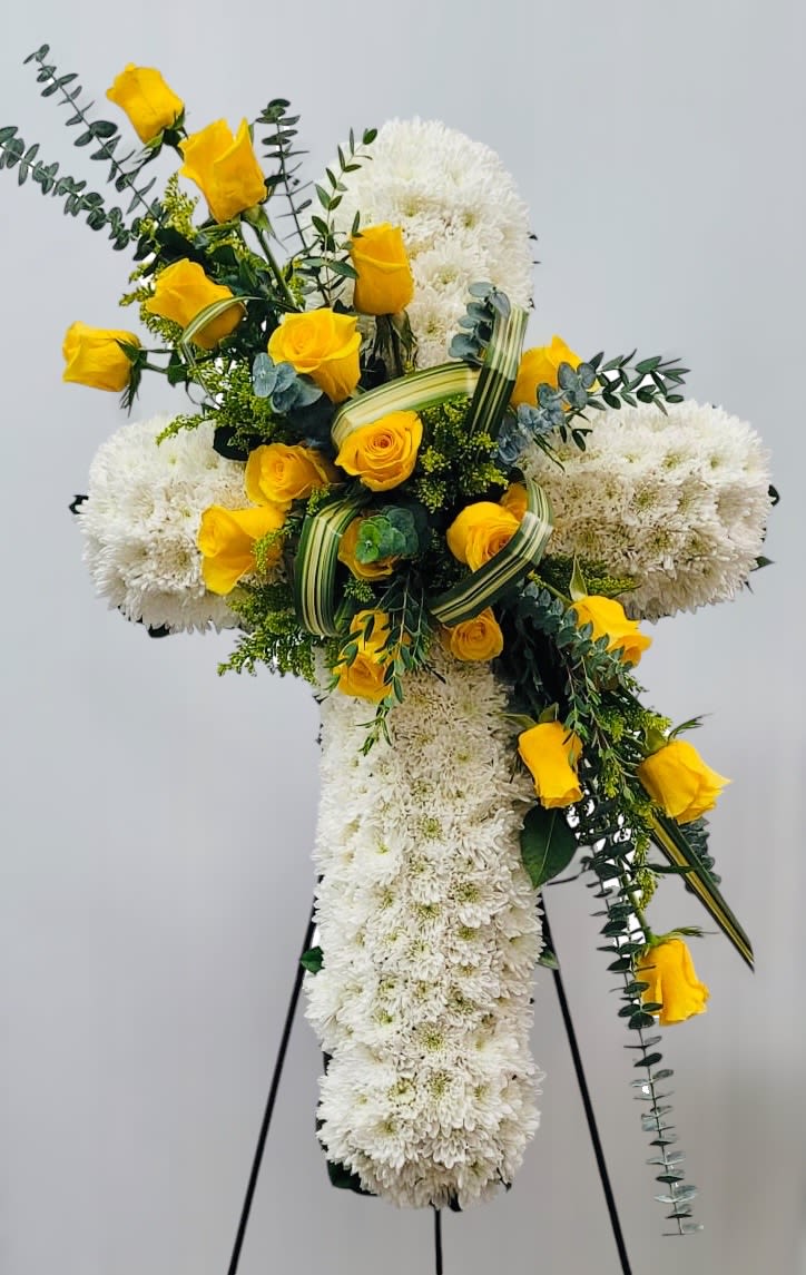 Cross-shaped floral tribute with yellow roses and white chrysanthemums