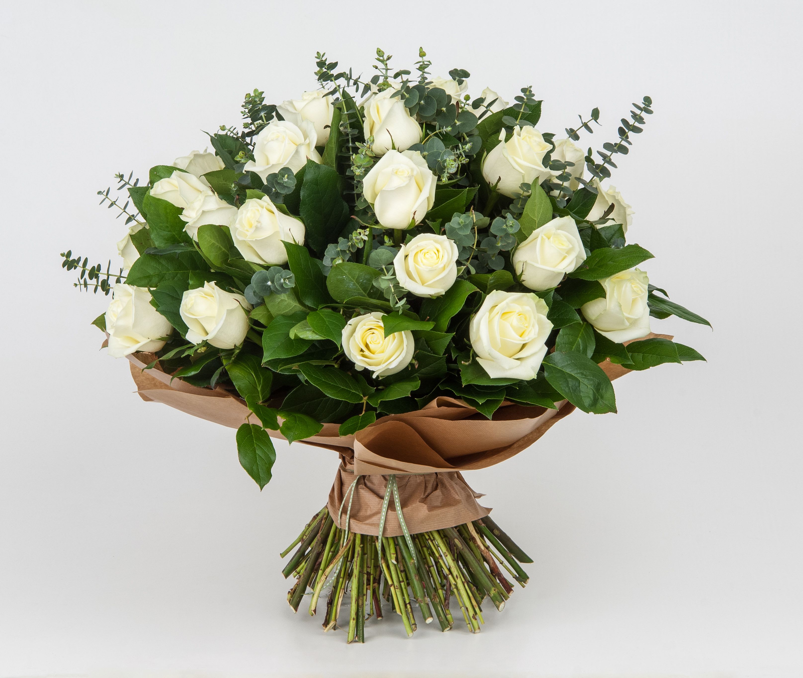 Bouquet of white roses with eucalyptus and brown paper wrap