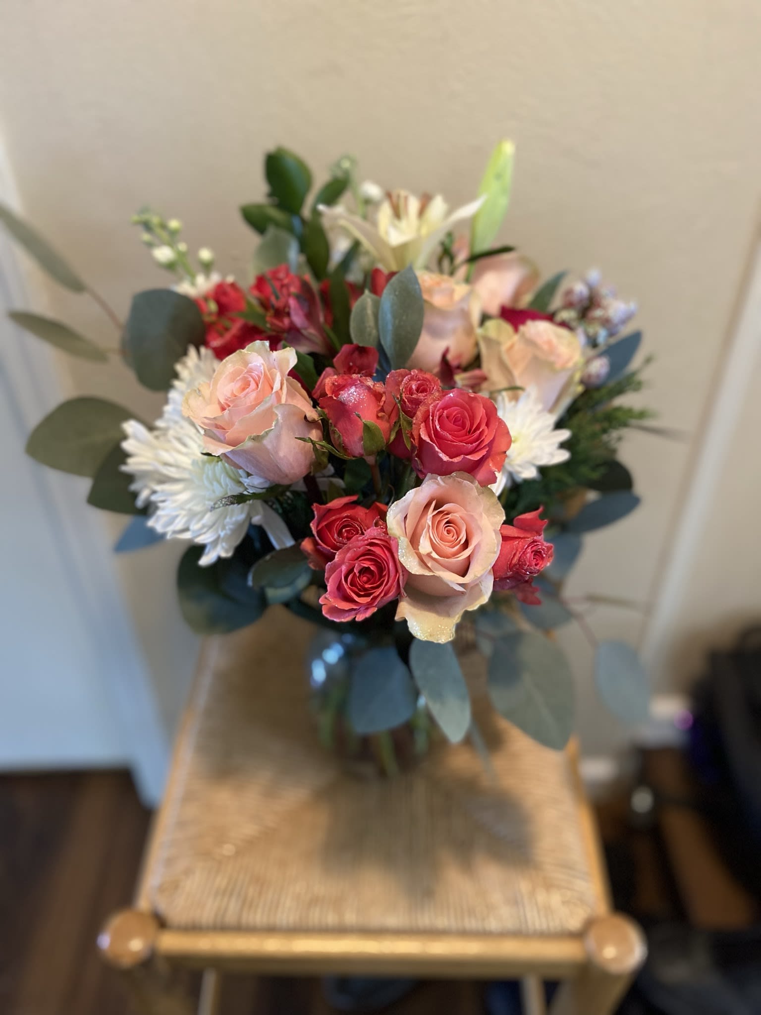 Frosted Pink - This beautifully custom design by Wonderland Flowers contains a mix of frosted pink roses, lilies, alstroemerias and poms. Sure to bring a sense of subtle cozy warmth to any room or office.  **Please note arrangement in picture is of regular priced arrangement. 