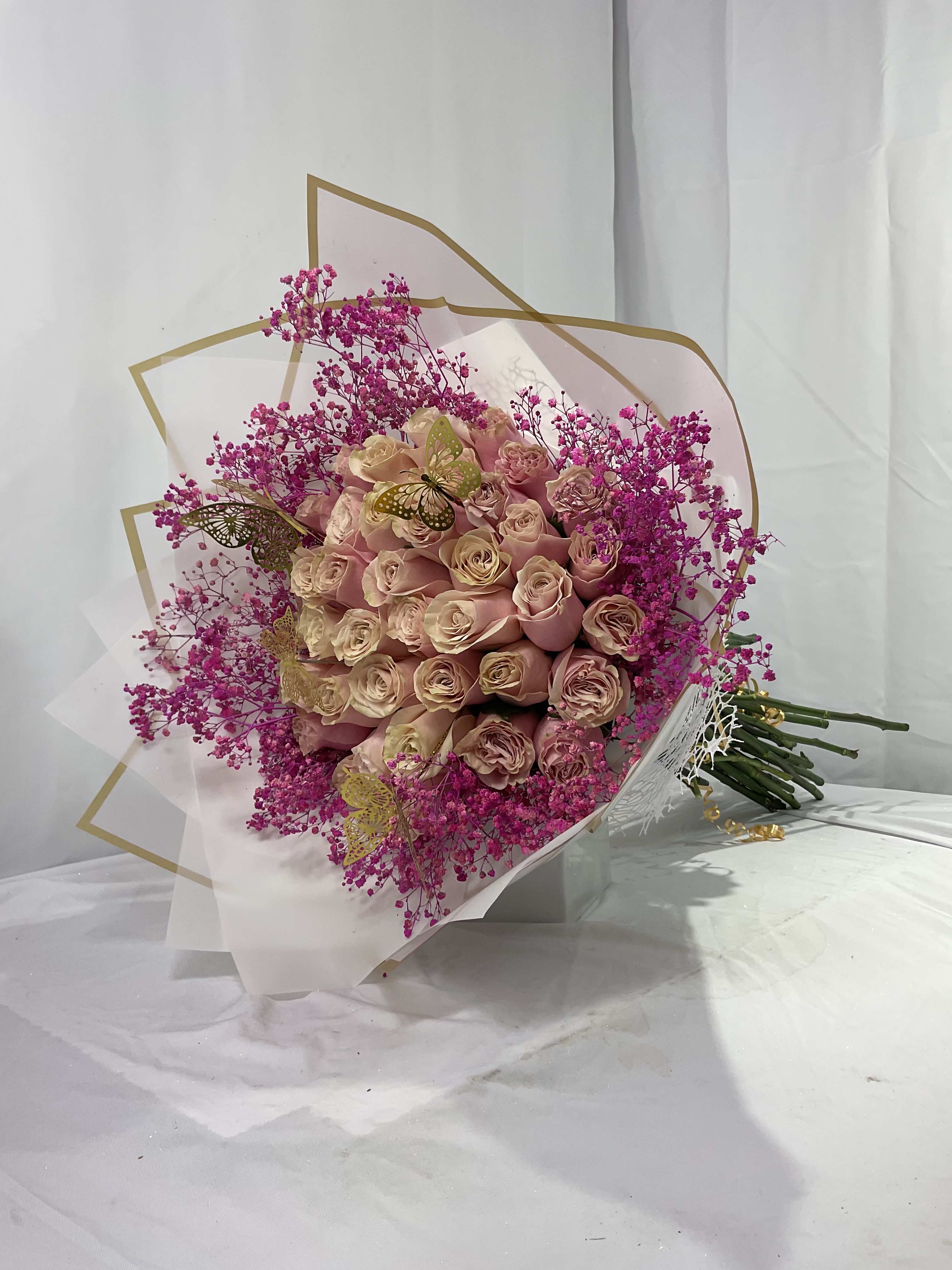 Bouquet of blush roses with bright pink filler flowers