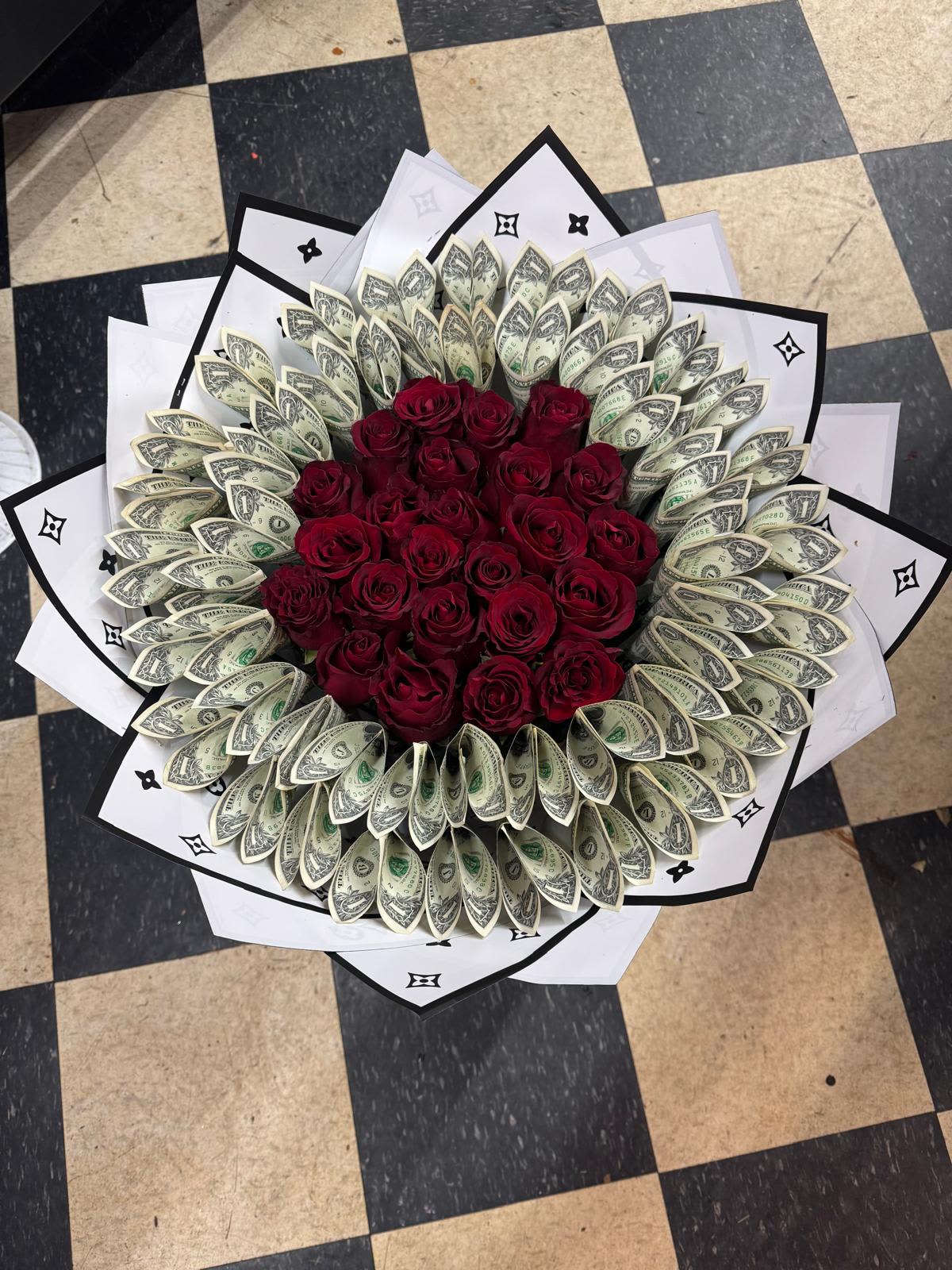 Bouquet of red roses surrounded by folded dollar bills