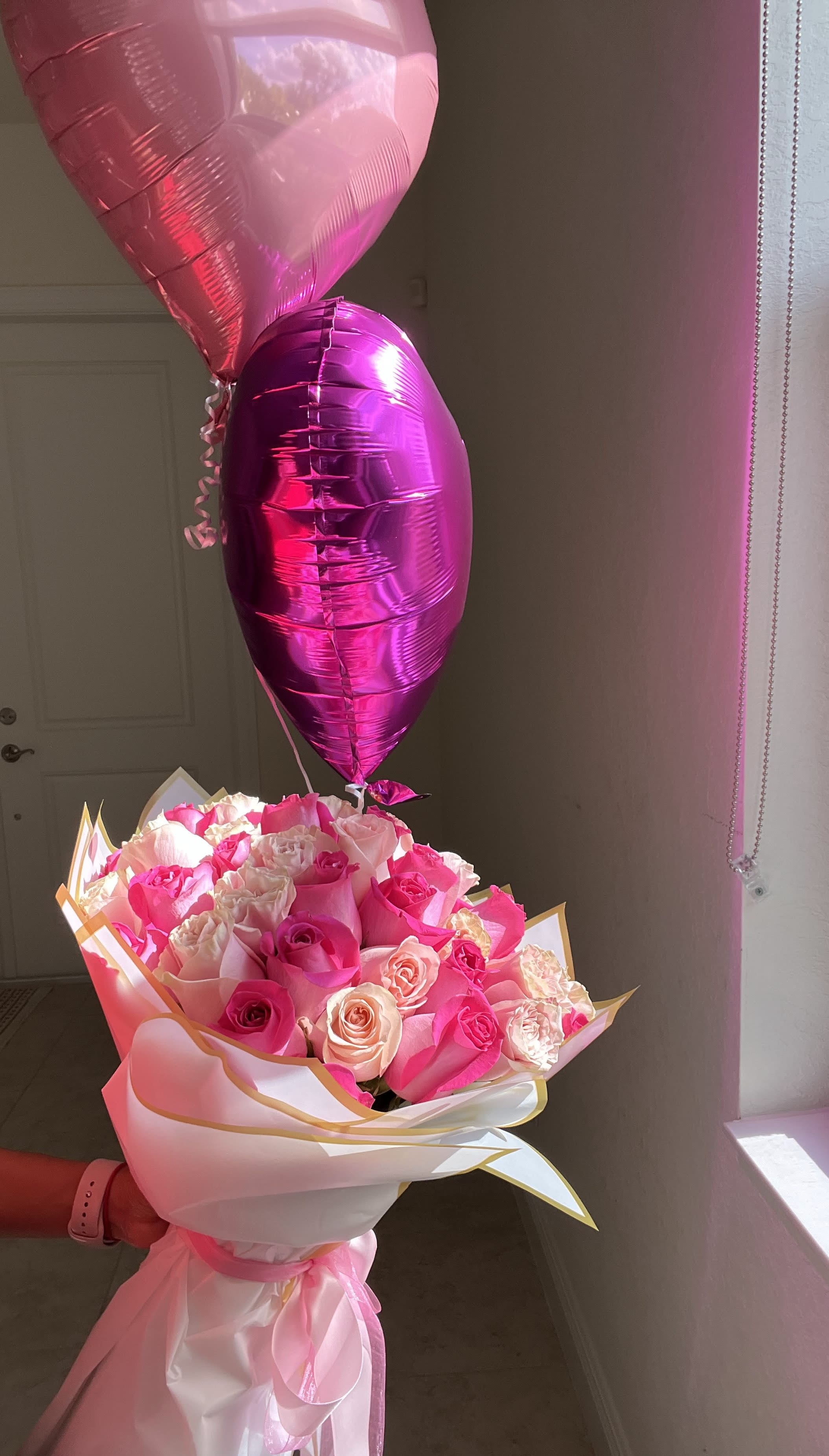 Pink rose bouquet with two heart-shaped balloons