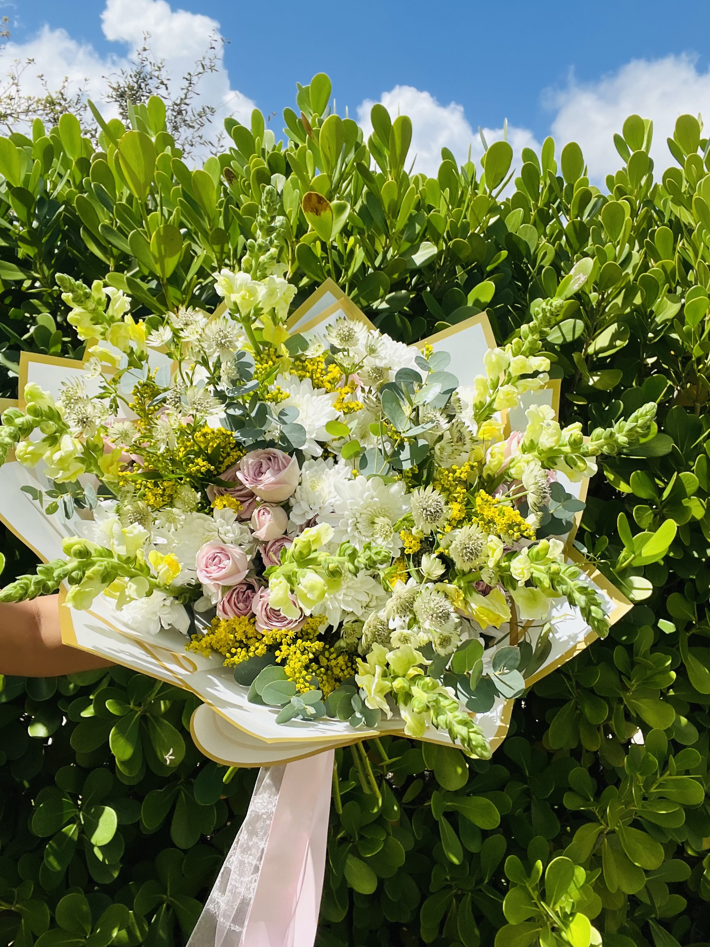 Soft Pink &amp; White Snapdragon Bouquet - Soft, delicate, and beautifully unique, our Soft Pink &amp; White Snapdragon Bouquet combines romantic pink tones with crisp whites, fresh eucalyptus, and an airy mix of textured accents. Pink spray roses add a touch of romance, while elegant snapdragons create height and movement throughout the design. White decorative palms and florist-selected fillers give the bouquet a modern, artistic finish that makes it stand out from a traditional mixed bouquet.  With its light and sophisticated color palette, this bouquet is perfect for birthdays, anniversaries, Mother’s Day, baby showers, bridal celebrations, congratulations, thank-you gifts, new babies, hostess gifts, or simply sending someone something beautiful and unexpected.  Each Amore Mio Roses bouquet is freshly made to order using high-quality flowers selected for freshness and beauty. Because we work with fresh and seasonal flowers, exact varieties, shades, greenery, fillers, and decorative accents may vary depending on availability. Thoughtful substitutions may be made while maintaining the overall soft pink, white and green color palette, airy style, quality, and value of the bouquet.