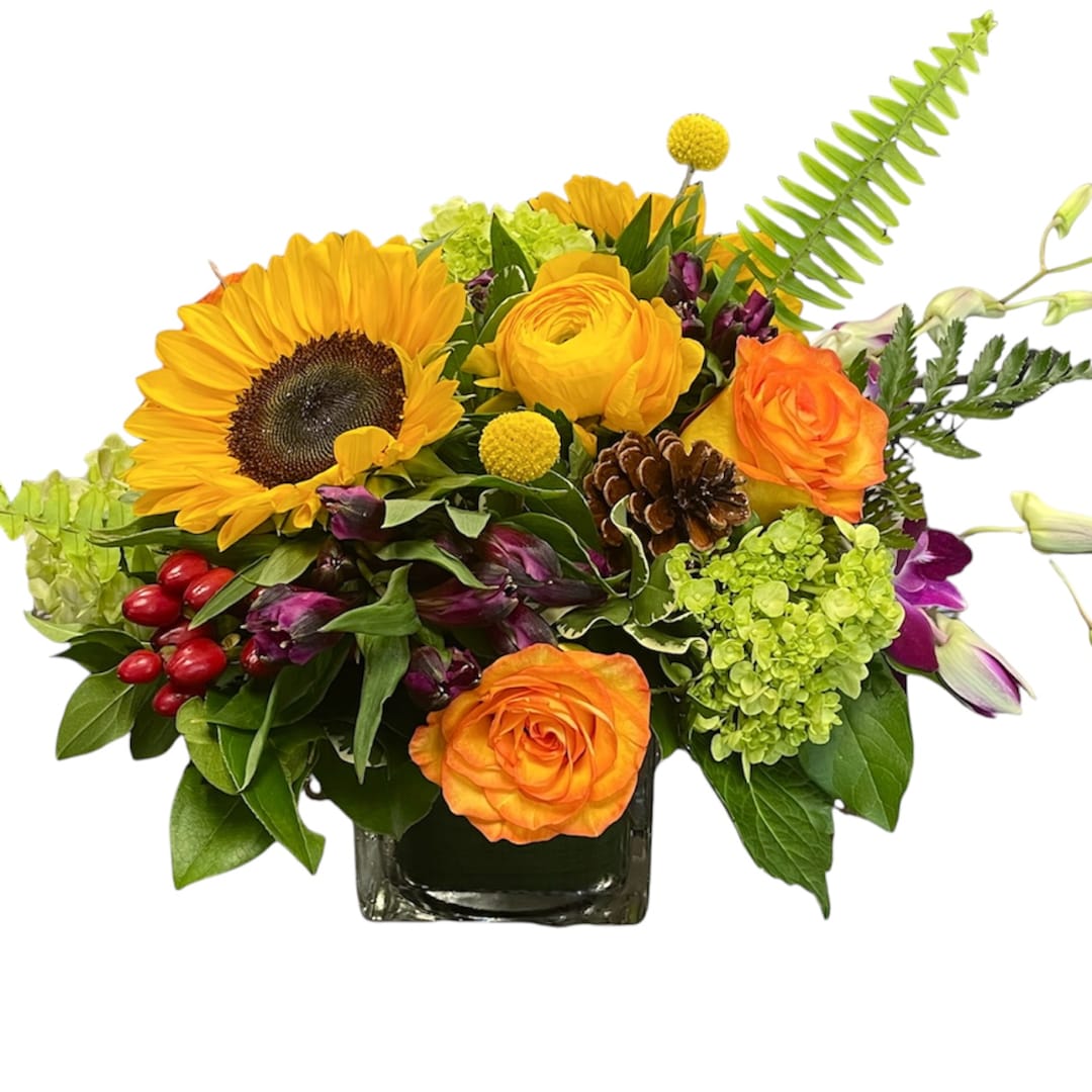 Mixed bouquet with sunflowers, orange roses, and green hydrangeas in a square vase