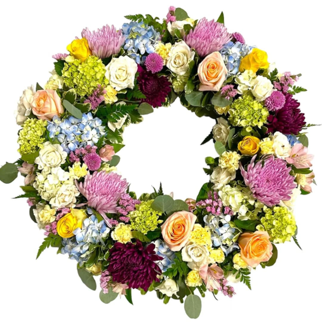 Circular floral wreath with roses, chrysanthemums, hydrangeas, and mixed blooms