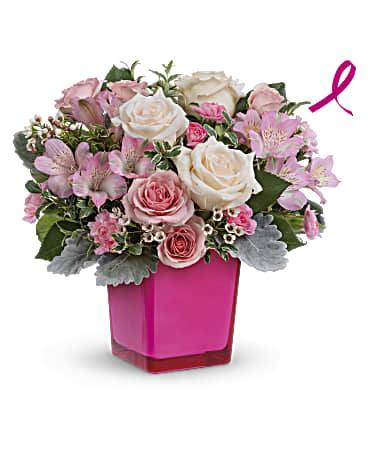 Teleflora's Be The Moment Bouquet - Make any moment magical with this breathtaking bevy of roses, presented to perfection in a hot pink glass cube that lives on as a cute candleholder. Send this featured bouquet and Teleflora will donate 15% of the purchase price to support the vital work of the Breast Cancer Research Foundation®. Crème roses, pink spray roses, pink alstroemeria and miniature pink carnations are arranged with white waxflower, dusty miller and oregonia. Delivered in Teleflora's Color Splash Cube. Orientation: All-Around