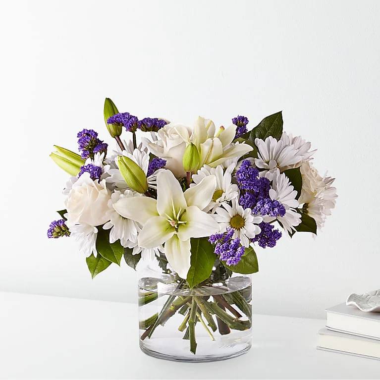 Beyond Blue Bouquet - BEYOND BLUE BOUQUET There is something about the shade of blue that brings a sense of calmness and serenity. Our Beyond Blue bouquet is designed with billowing white blooms and pops of bold florals to deliver just the right sentiment for any reason.