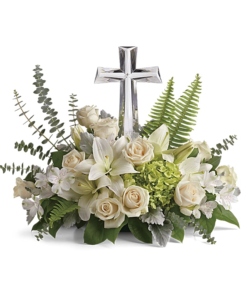 Life's Glory Bouquet by Teleflora - This reverant bouquet of serene white flowers is a beautiful sharing of sympathy, adorned with a majestic crystal cross keepsake. Green hydrangea, crème roses, white asiatic lilies, and white alstroemeria are accented with dusty miller, sword fern, spiral eucalyptus, and lemon leaf. Delivered with Teleflora's Large Crystal Cross Keepsake. Orientation: One-Sided