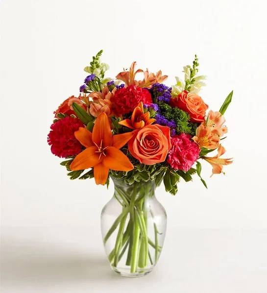 Vibrant Floral Medley™ - About Vibrant Floral Medley™ LOCAL ARTISAN EXCLUSIVE Putting a bright start in somebody’s day starts with a beautiful gift. Our delightfully vibrant bouquet is filled with a medley of blooms in cheerful pops of orange, hot pink and yellow, with plenty of lush greenery mixed in. Designed by the talented Breanna Cartwright from Fresh Ideas Flowers Company in Modesto, California, it’s the perfect pick-me-up surprise, whatever the sentiment