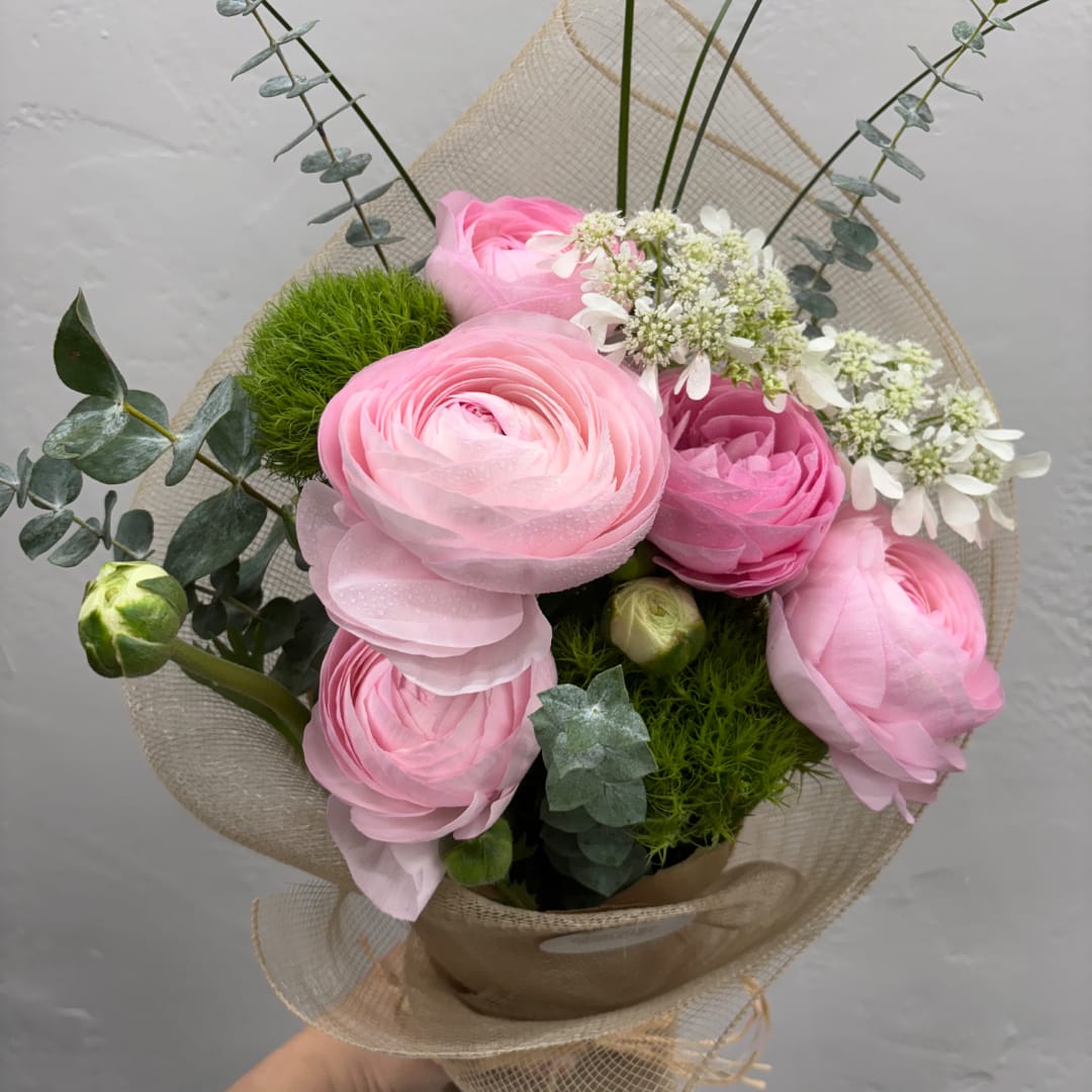 Pink ranunculus bouquet with eucalyptus and white filler flowers