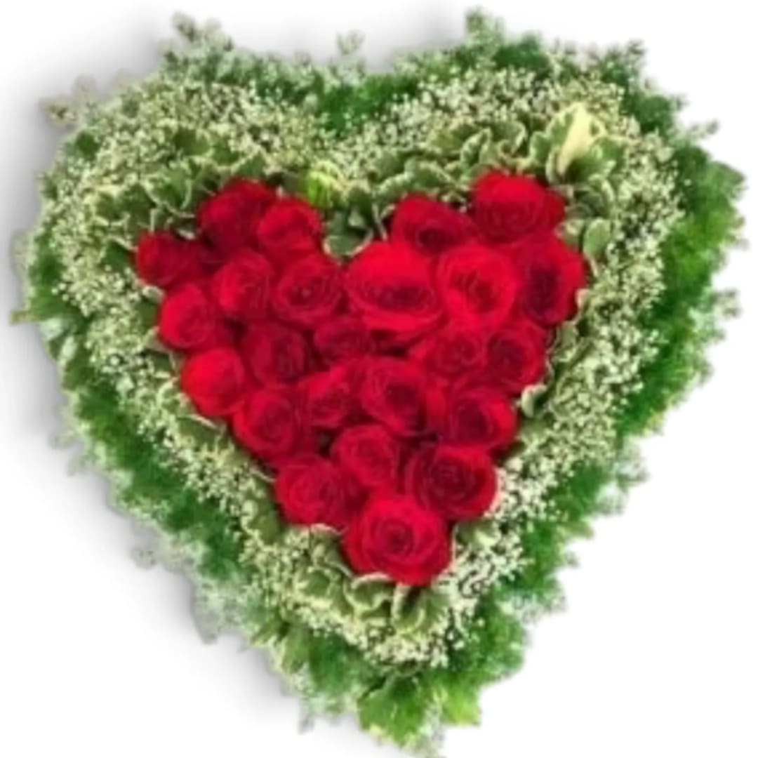 Heart-shaped arrangement of red roses with a green and white floral border