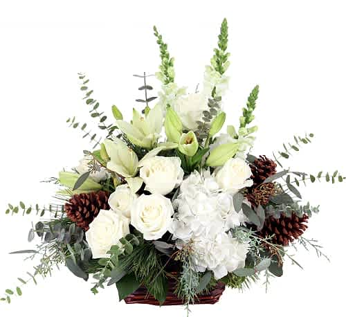 Festive Moments Holiday Basket - A classic and elegant display of all white holiday blooms. This joyful arrangement includes hydrangea, roses, lilies and more in a rustic feeling holiday basket. 