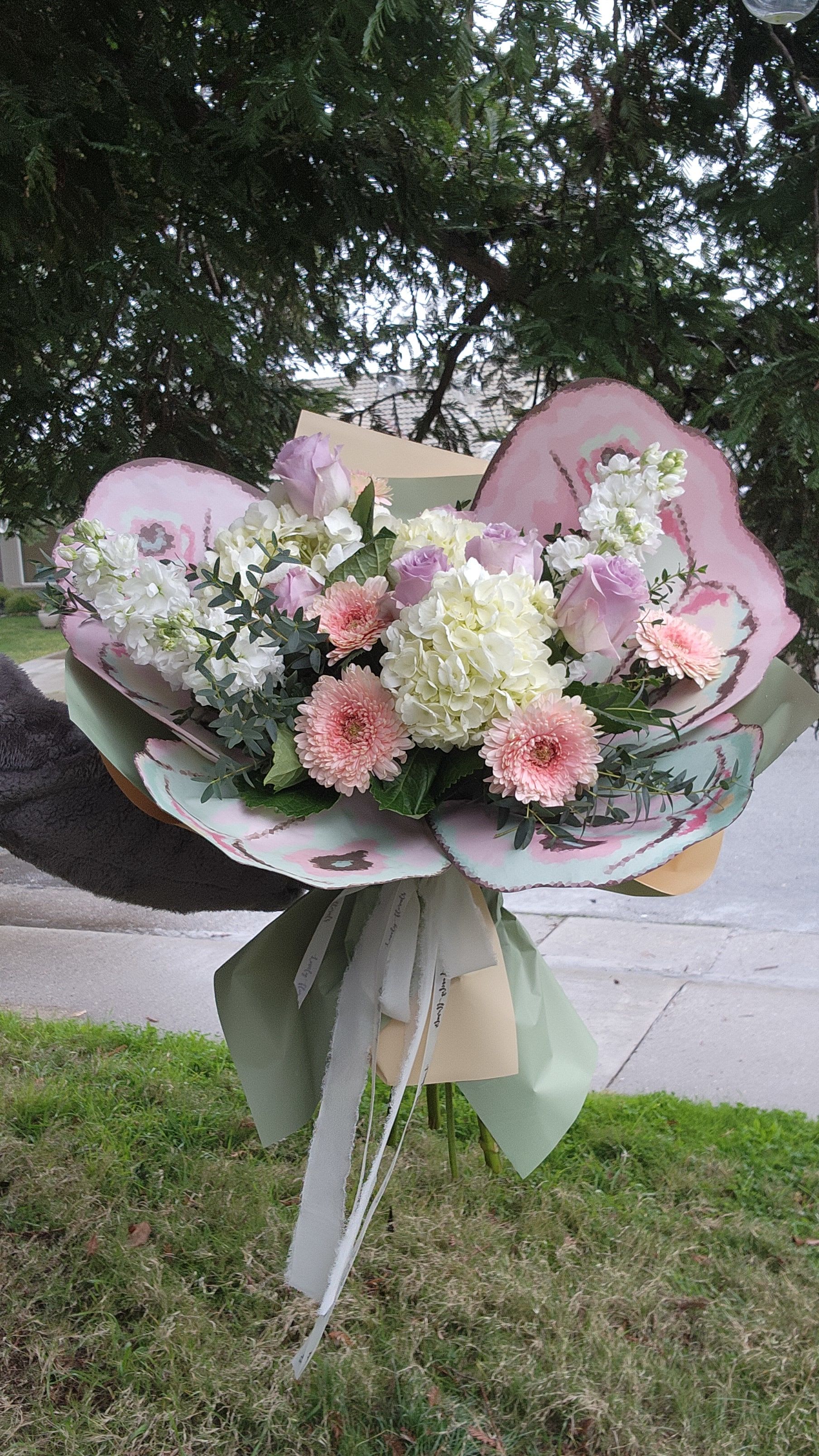 Butterfly Kisses  - This is very unique arrangement with a beautiful butterfly wings. The flowers included in this arrangement are hydrangea, gerberas, stock, and lavender roses.