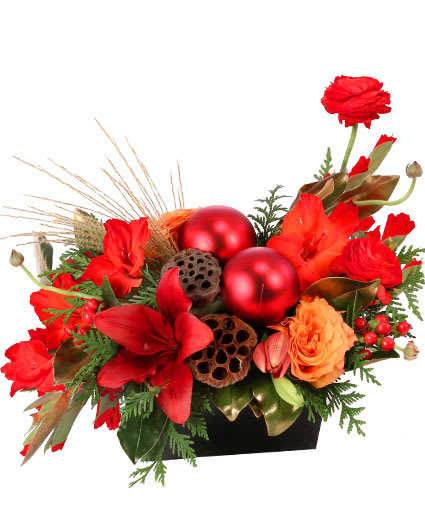 RAVISHING RICH RED CHRISTMAS ARRANGEMENT  - If you are looking for a stunning centerpiece, Ravishing Rich Red has you covered! With red gladiolus, lilies, ranunculus, and Free Spirit roses, this design is sure to bring the season's greetings to any table. Send these jolly flowers to someone who loves to decorate for the holidays! 