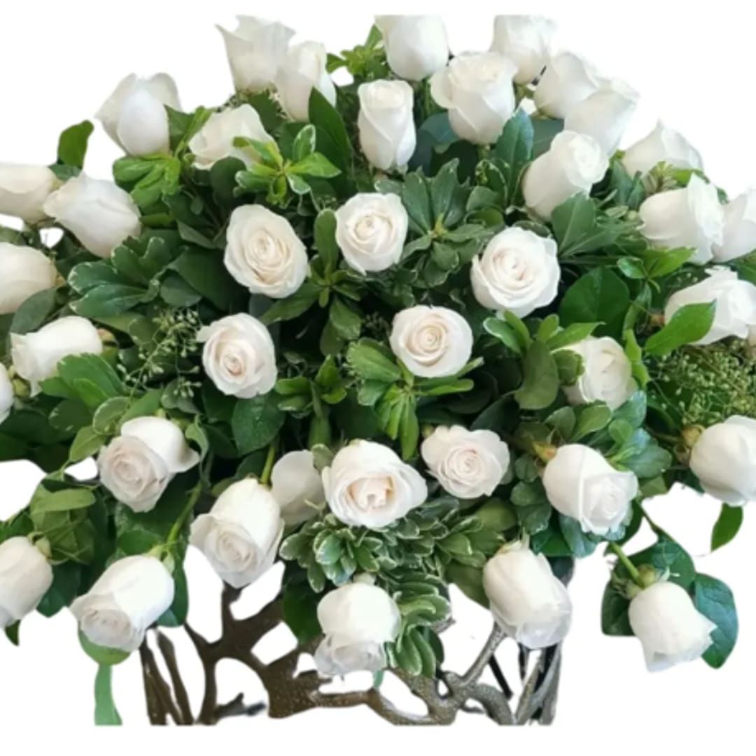 White roses arranged in a dense bouquet with green foliage