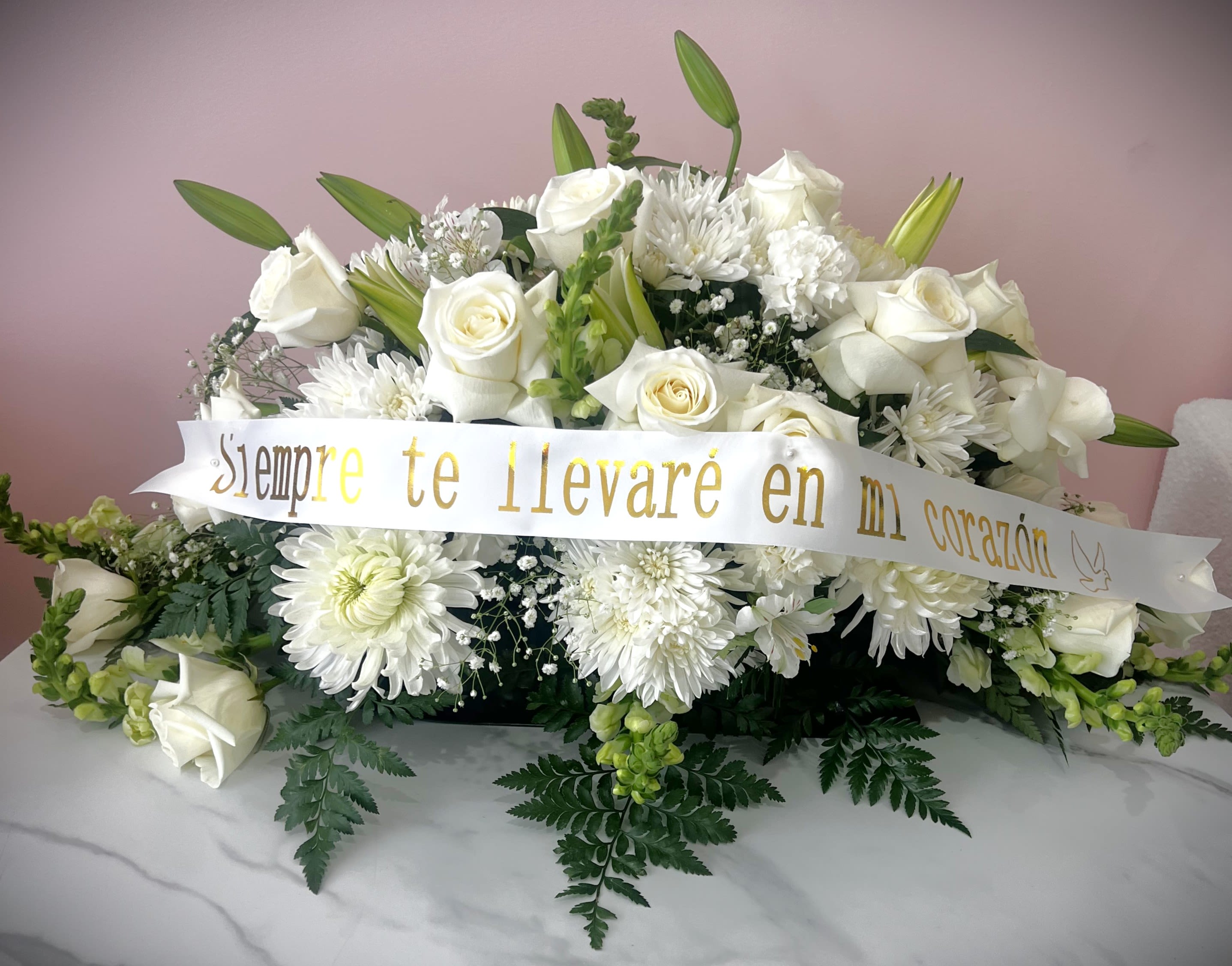 White rose and chrysanthemum arrangement with a memorial ribbon