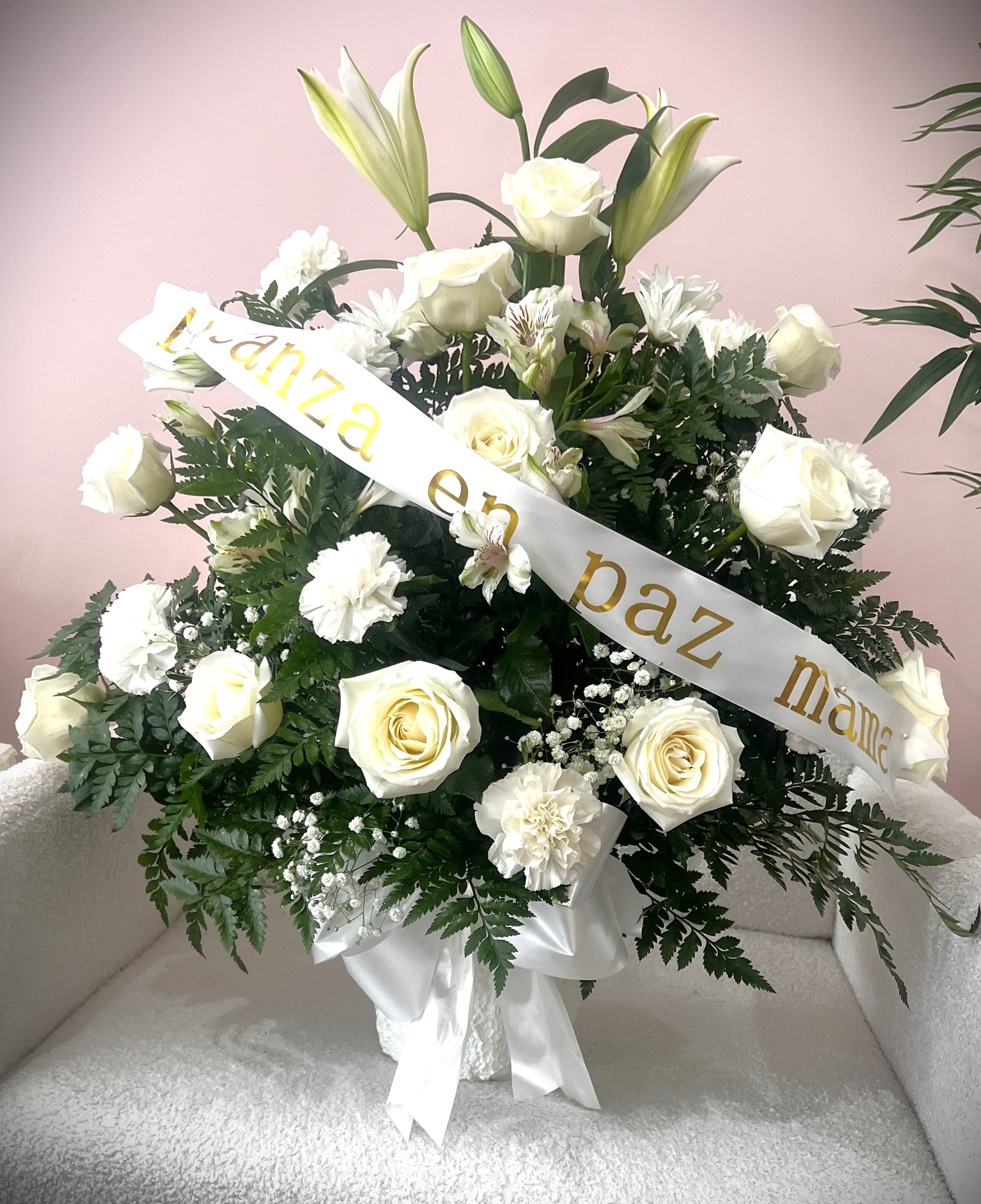 White rose and lily arrangement with a condolence ribbon