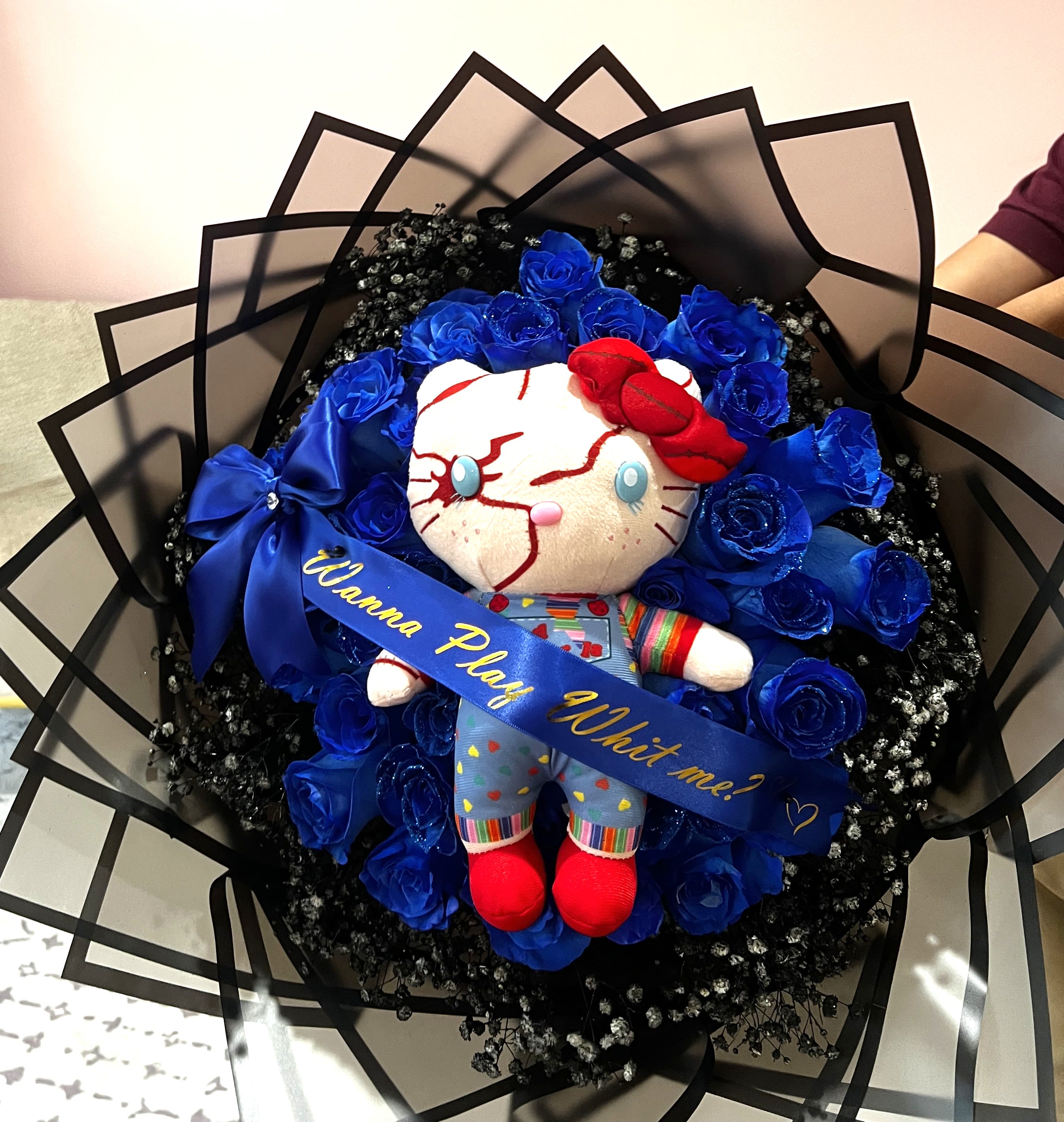 Bouquet with blue roses and a plush doll in the center