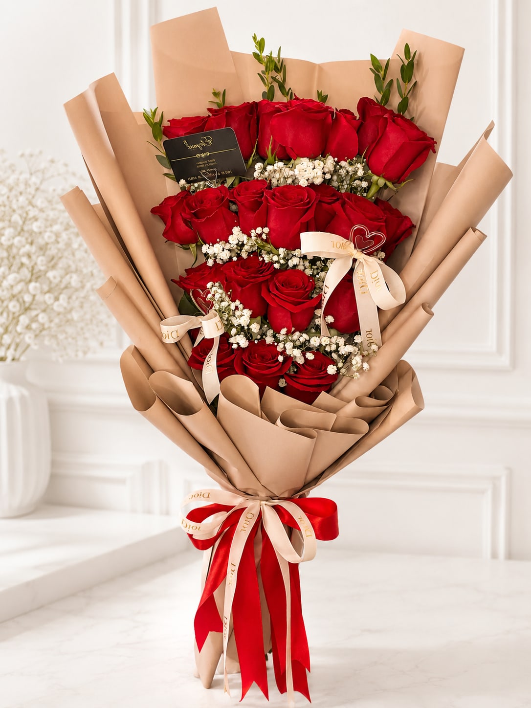 Bouquet of red roses wrapped in tan paper with ribbon