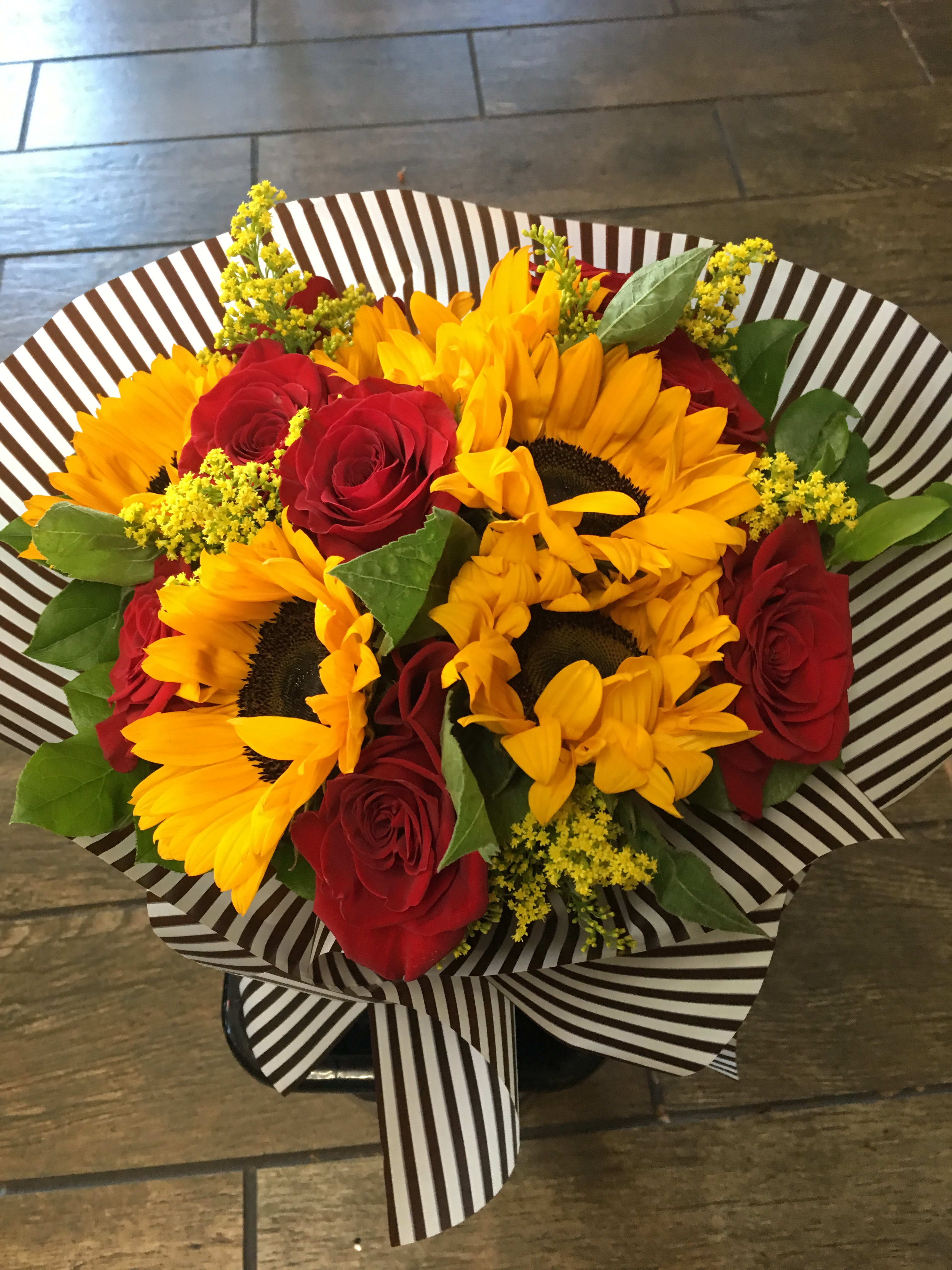 Ray of Sunshine bouquet - Hand tie bouquet may consist of sunflower, roses, solidaster, and foliage  Note: it may also be wrap in craft, burlap, cellophane 