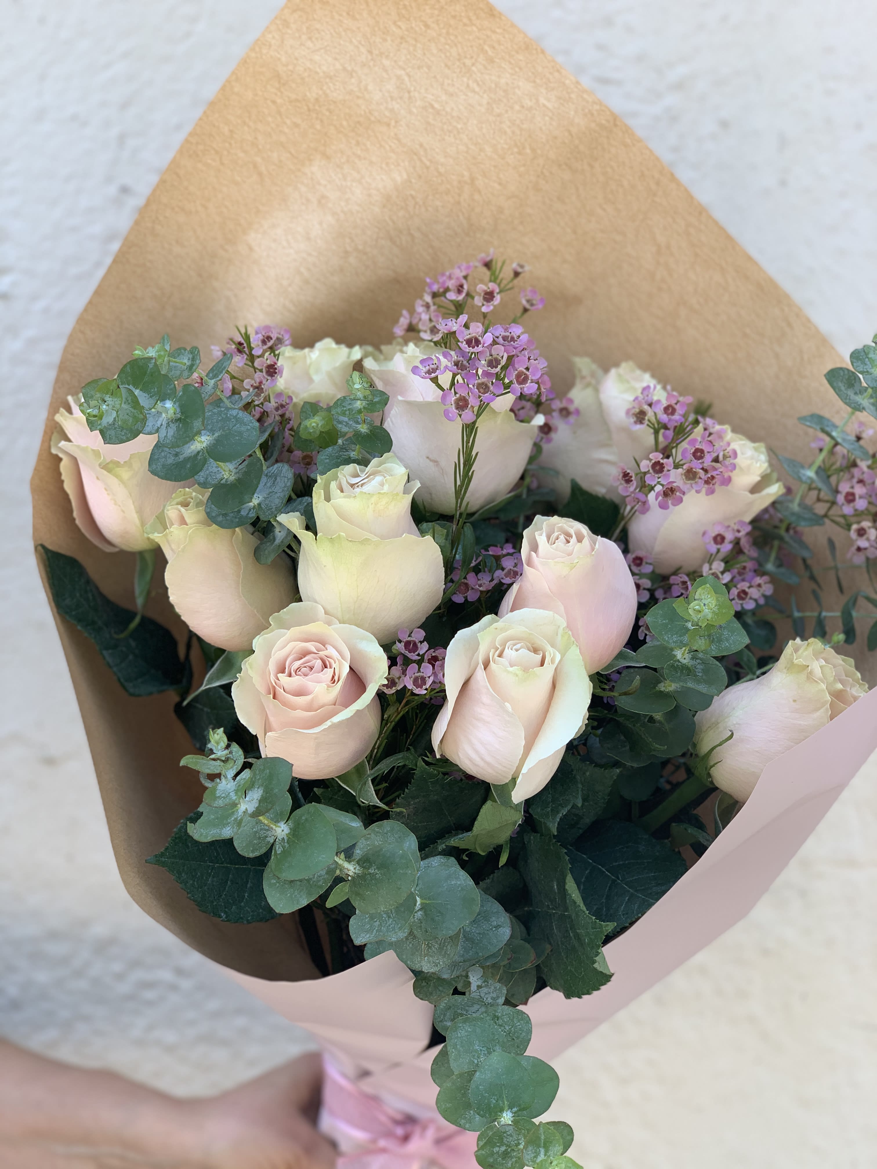 Soft Pink - Dozen roses with fillers tied into a bouquet.