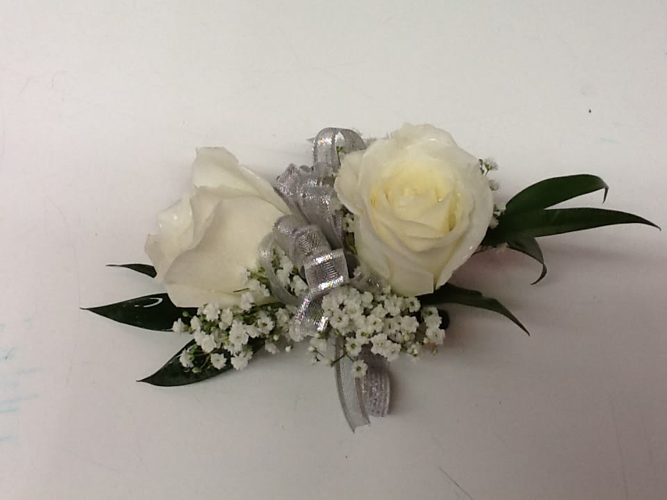 White rose boutonniere with silver ribbon and baby's breath