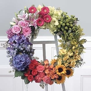 Garden Wreath - Garden Wreath | 24-Inch Funeral Wreath | Wilmington, Delaware Sympathy Flowers Celebrate a vibrant life with our Garden Wreath, a stunning 24-inch funeral wreath handcrafted by Petals Flowers and Fine Gifts in Wilmington, Delaware. Bursting with a rainbow of colors, this lush arrangement features a beautiful mix of white, pink, purple, orange, yellow, and green blooms—artfully designed to create a joyful yet heartfelt tribute for a funeral, memorial service, or celebration of life.  The Garden Wreath is a symbol of remembrance, renewal, and the colorful impact your loved one had on the world. Its full, garden-inspired style and circular shape represent eternal love and unending support, offering comfort and beauty during times of loss.  As a trusted local florist in Wilmington, Delaware, Petals Flowers and Fine Gifts is known for creating meaningful, custom sympathy arrangements with care and creativity. We offer same-day, tax-free flower delivery to all local funeral homes, churches, and residences throughout Wilmington, Newark, Hockessin, Chadds Ford, Glen Mills, Kennett Square, and surrounding communities.  Why Choose Petals Flowers and Fine Gifts?  * Custom, premium funeral wreaths and sympathy flowers * Locally owned Wilmington florist with compassionate service * Same-day, tax-free delivery across the Delaware area Send the Garden Wreath today to honor a cherished life with a floral tribute full of color, beauty, and love.