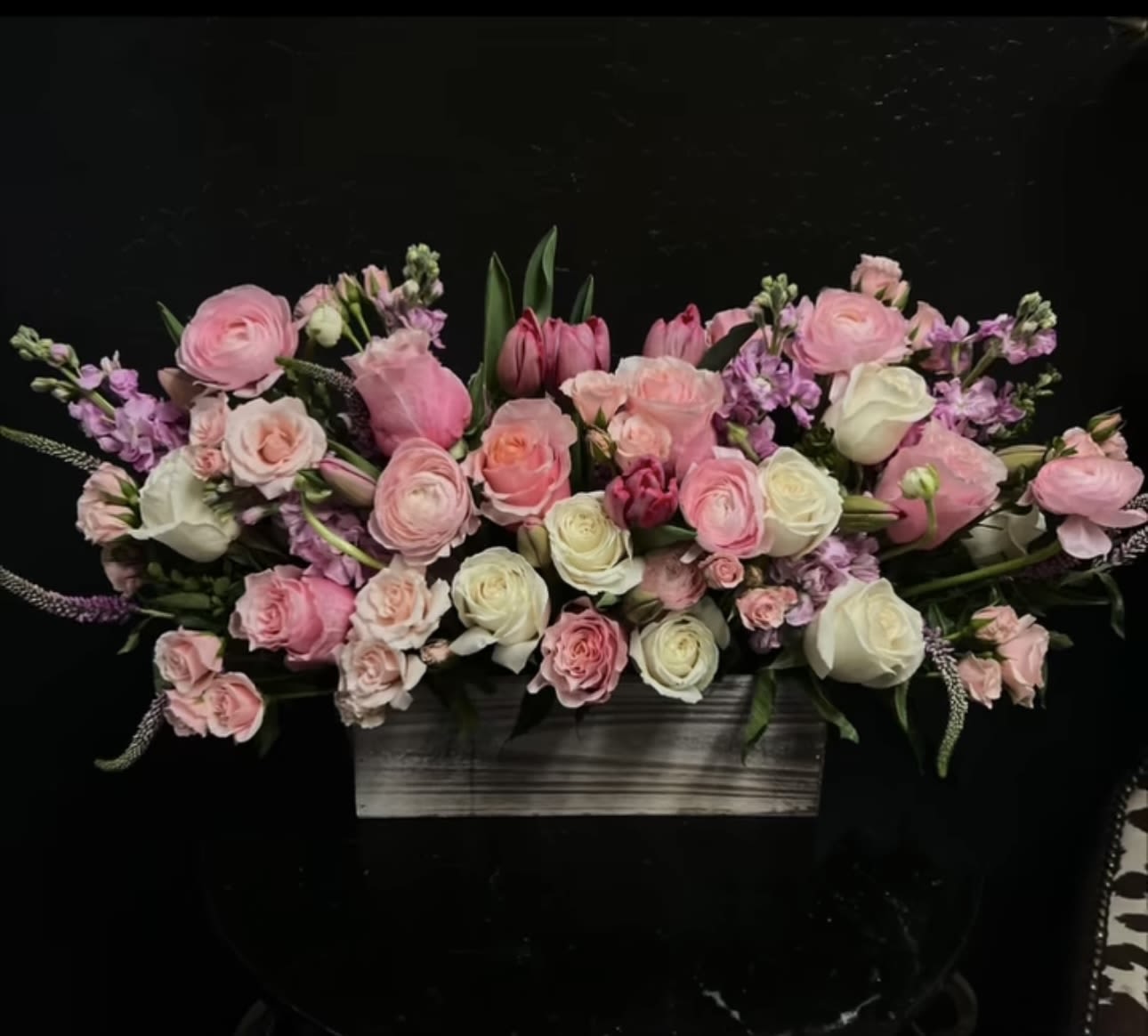 Pink and white floral arrangement in a rectangular wooden container