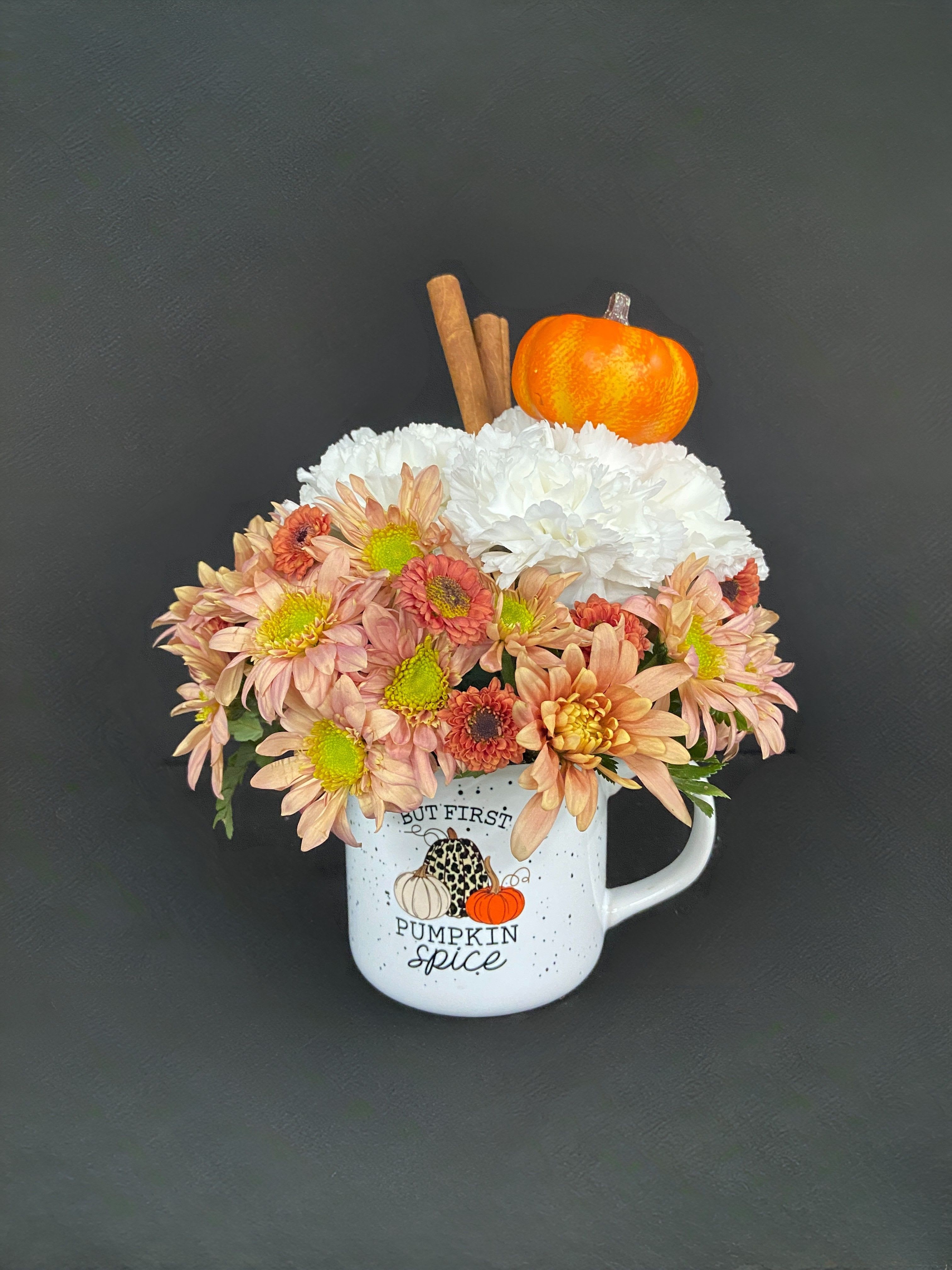 Mug arrangement of peach and white chrysanthemums with a pumpkin topper