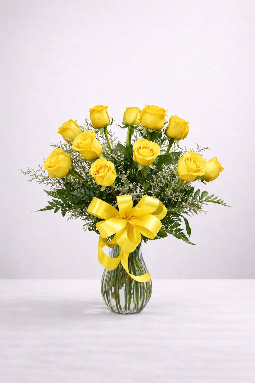 Yellow Roses - Meaning: Friendship, joy, happiness, and new beginnings  Yellow roses symbolize warmth and positivity, making them a perfect choice for celebrating friendships, sending well-wishes, or brightening someone’s day. Accent flowers and greenery may vary depending on seasonal availability.  Standard: 12 roses Deluxe: 18 roses Premium: 24 roses  Looking for a different number of roses? Please call our store at (215) 220-1000 and we’ll be happy to create a custom arrangement for you.
