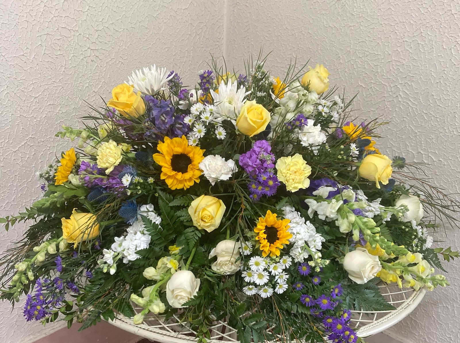 Mixed bouquet with yellow roses, sunflowers, and white blooms