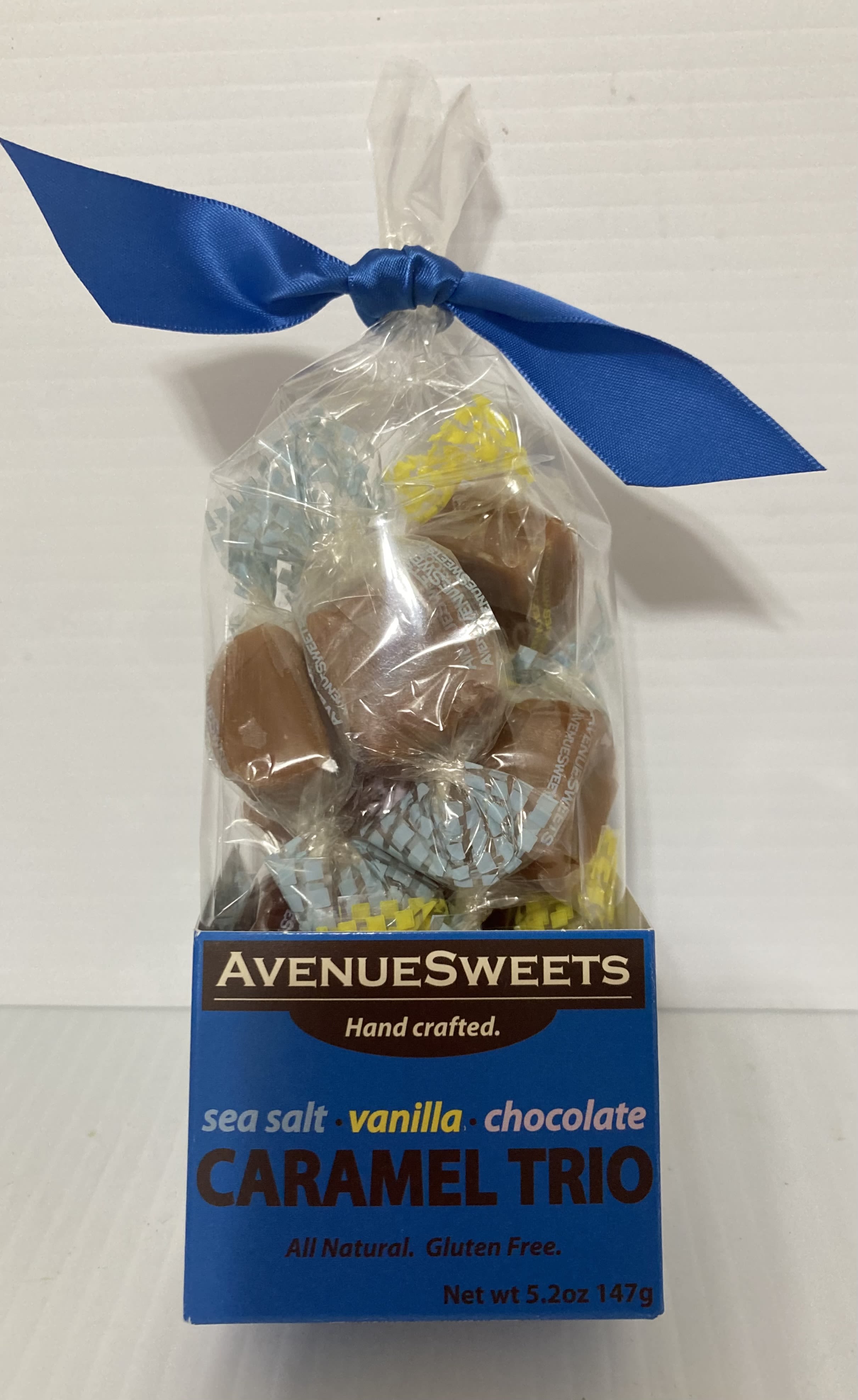 Bag of caramel trio candies tied with a blue ribbon