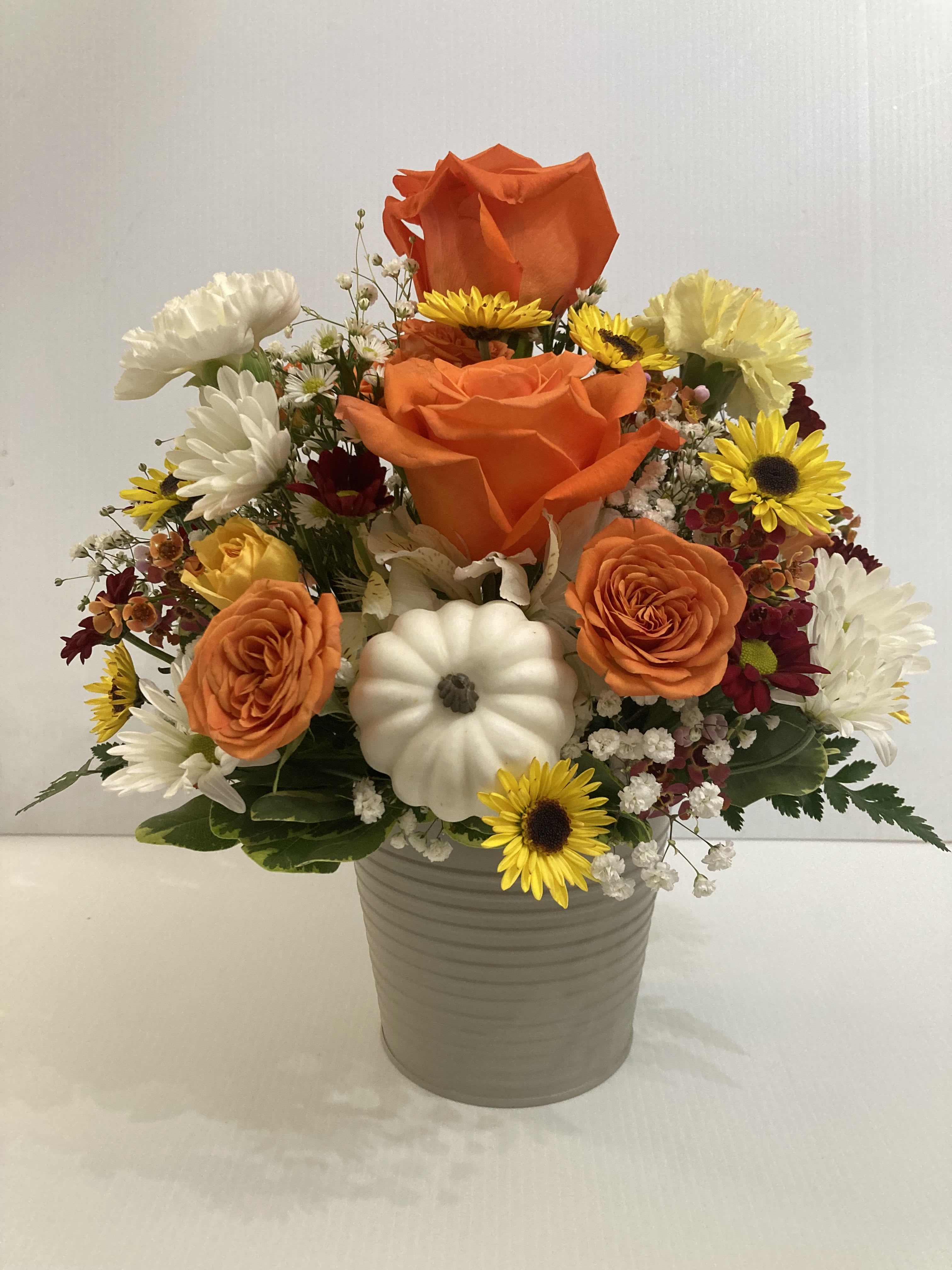 Thankful - Beautiful arrangement in colorful metal container with Roses, Carnations, Daisies, spray roses, greens and filler